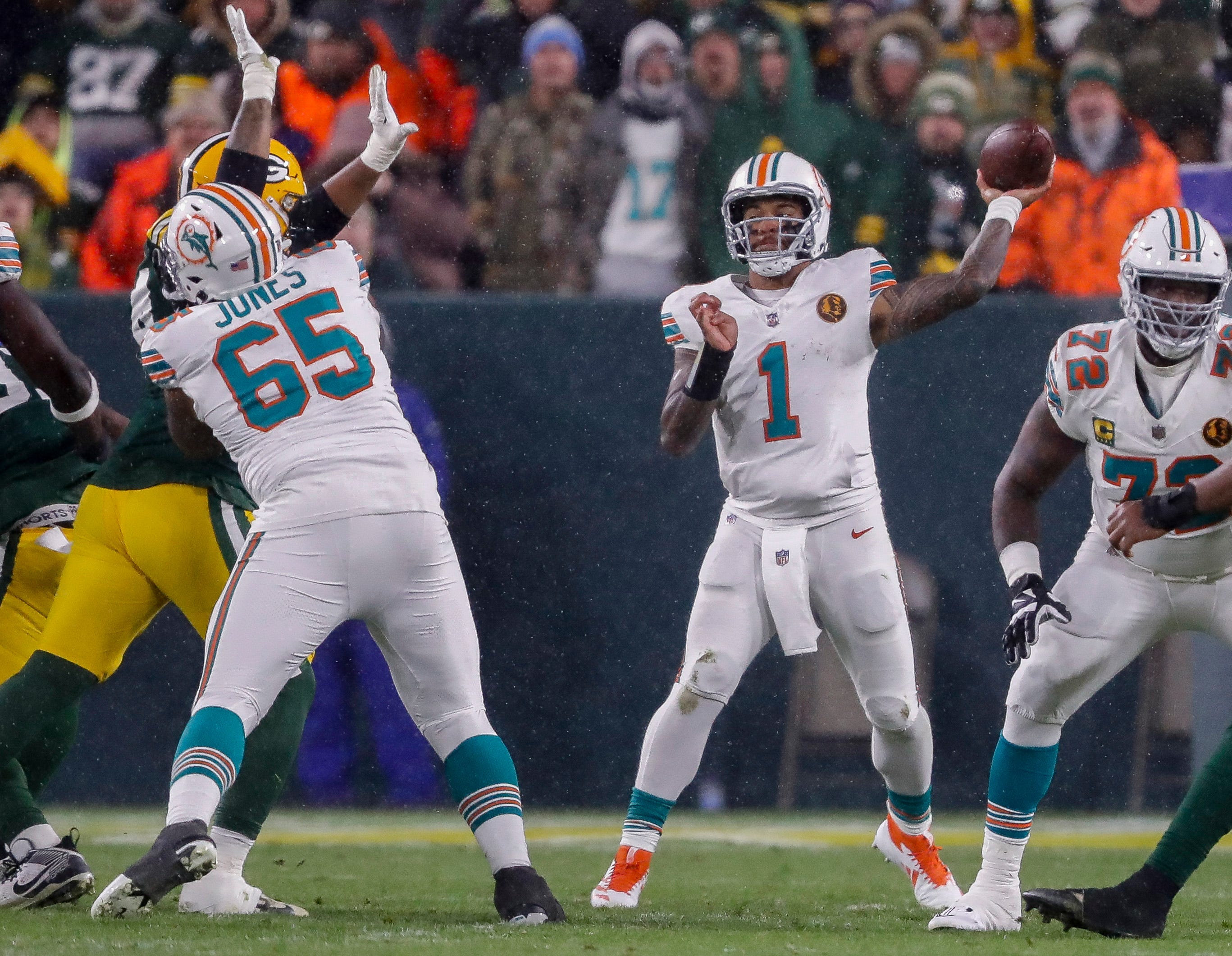 Miami Dolphins quarterback Tua Tagovailoa (1) passes the ball against the Green Bay Packers on Thursday, November 28, 2024, at Lambeau Field in Green Bay, Wis. The Packers won the game, 30-17.