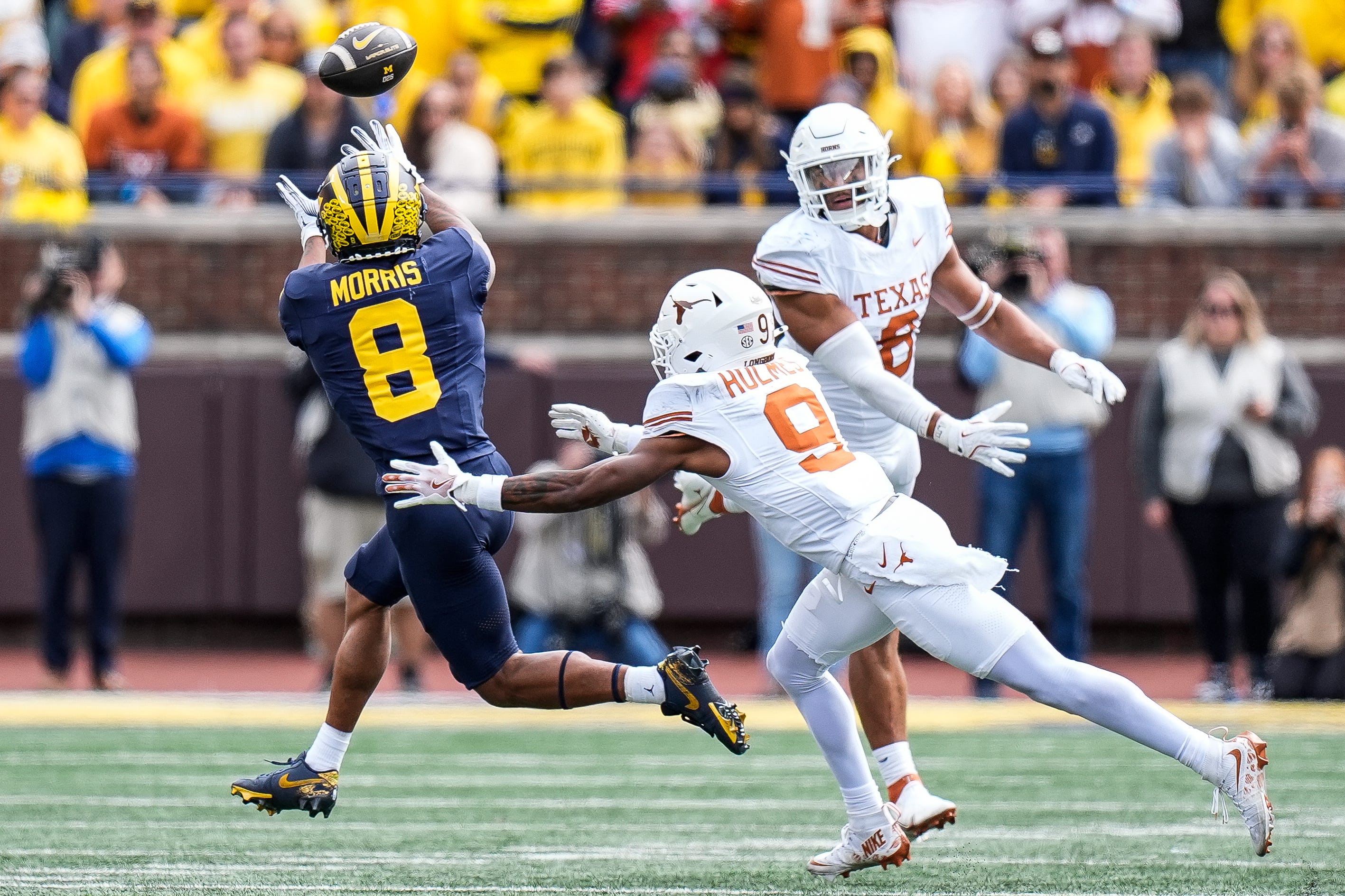 Michigan wide receiver Tyler Morris (8) makes a catch against Texas defensive back Gavin Holmes (9) during the second half at Michigan Stadium in Ann Arbor on Saturday, September 7, 2024.