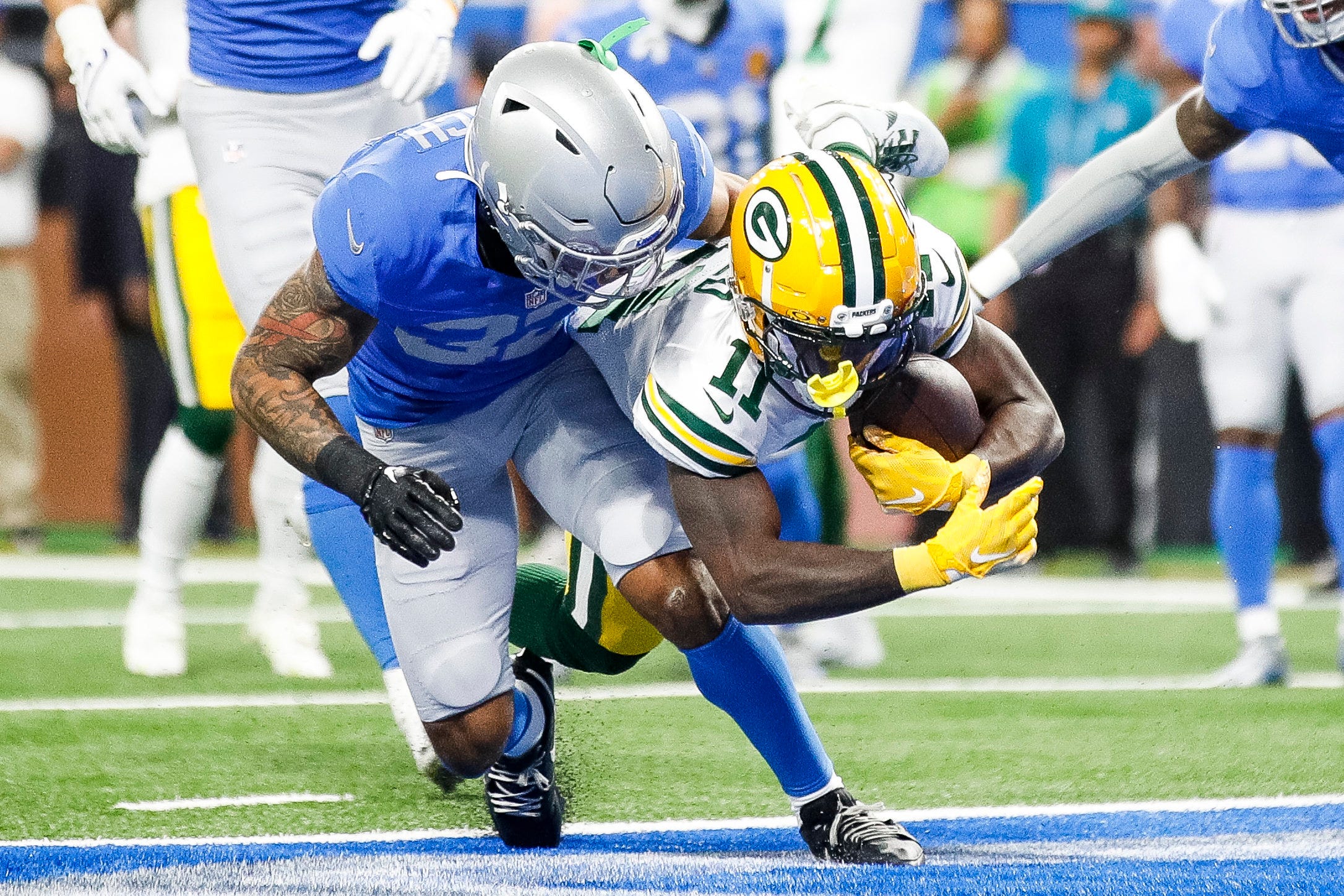 Green Bay Packers receiver Jayden Reed catches a touchdown against Detroit Lions safety Brian Branch during the first quarter at Ford Field in Detroit on Thursday, Nov. 23, 2023