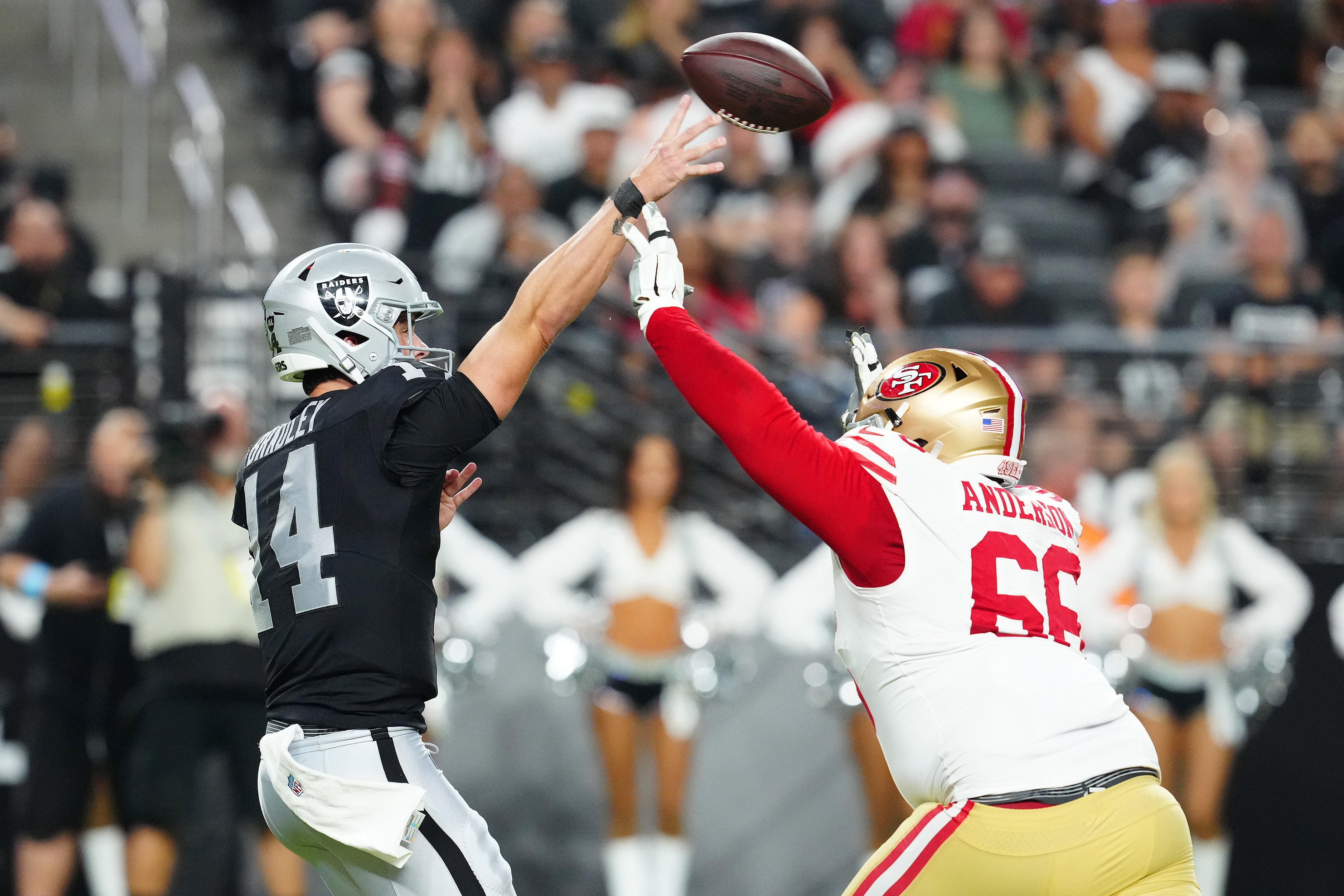 Las Vegas Raiders quarterback Carter Bradley (14) is pressured by San Francisco 49ers defensive lineman Evan Anderson (66) during the fourth quarter at Allegiant Stadium.