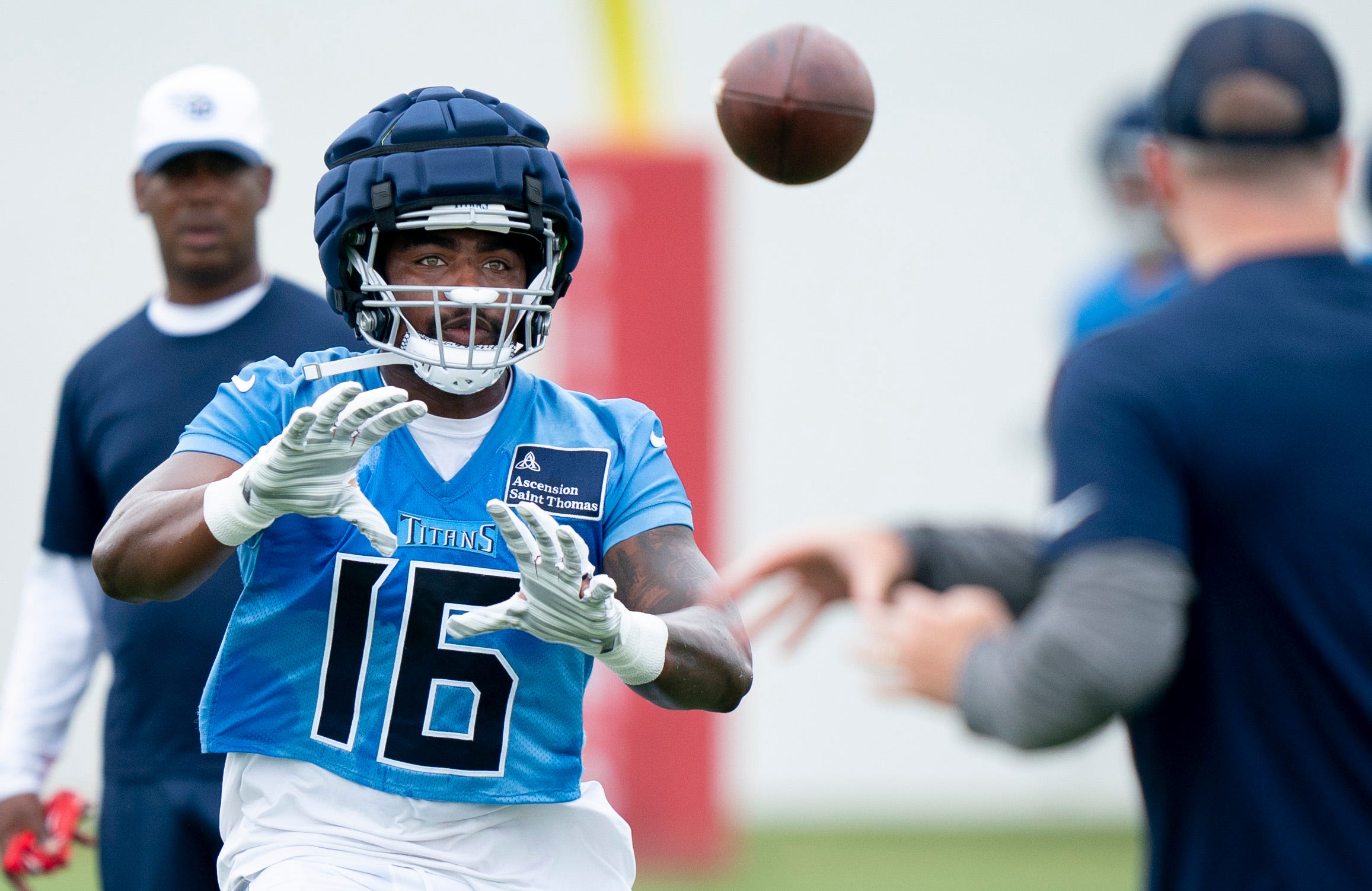 Tennessee Titans wide receiver Treylon Burks (16) eyes a pass on the first day of training camp at Ascension Saint Thomas Sports Park Wednesday, July 24, 2024.