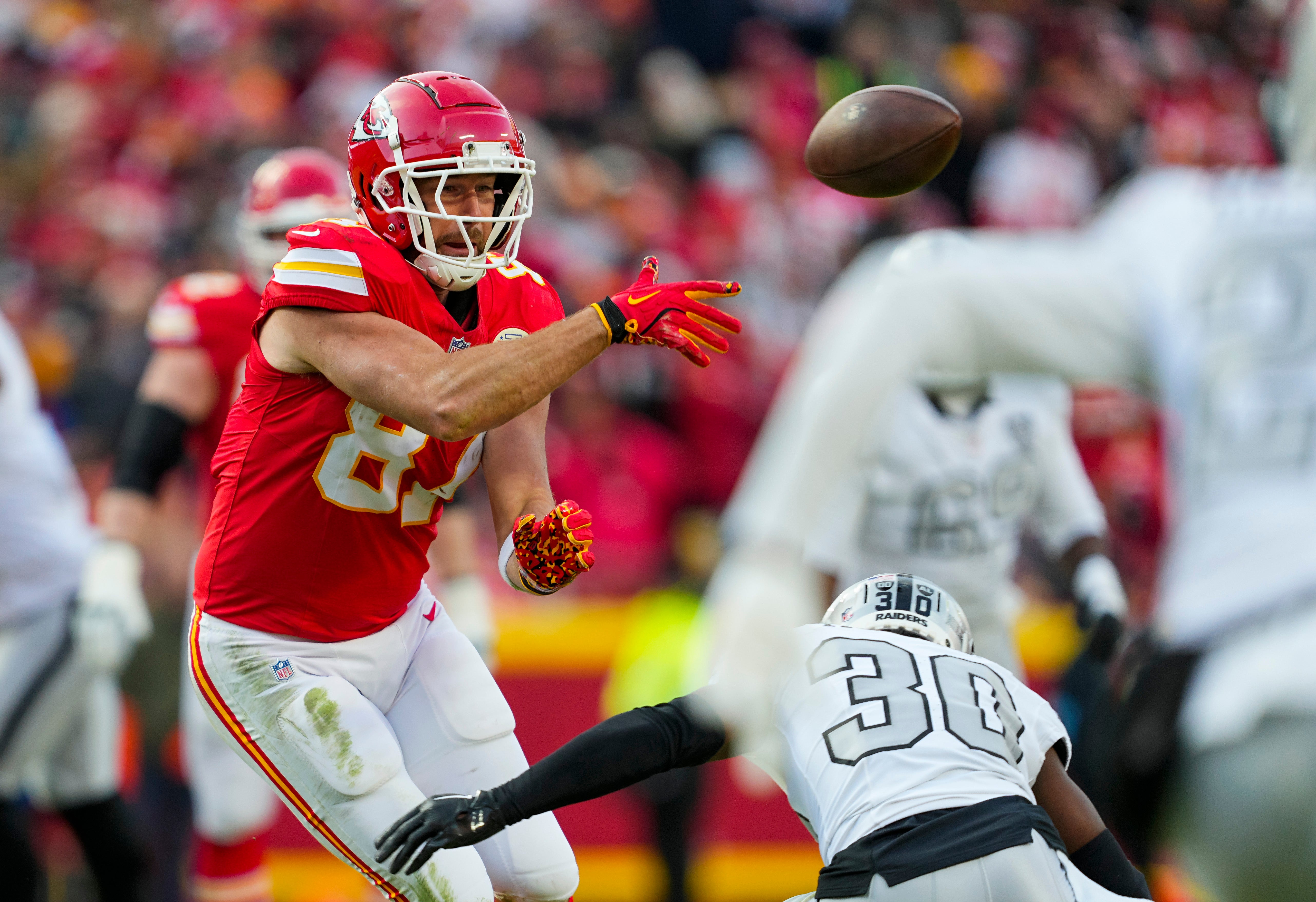 Nov 29, 2024; Kansas City, Missouri, USA; Kansas City Chiefs tight end Travis Kelce (87) laterals the ball during the first half against the Las Vegas Raiders at GEHA Field at Arrowhead Stadium.