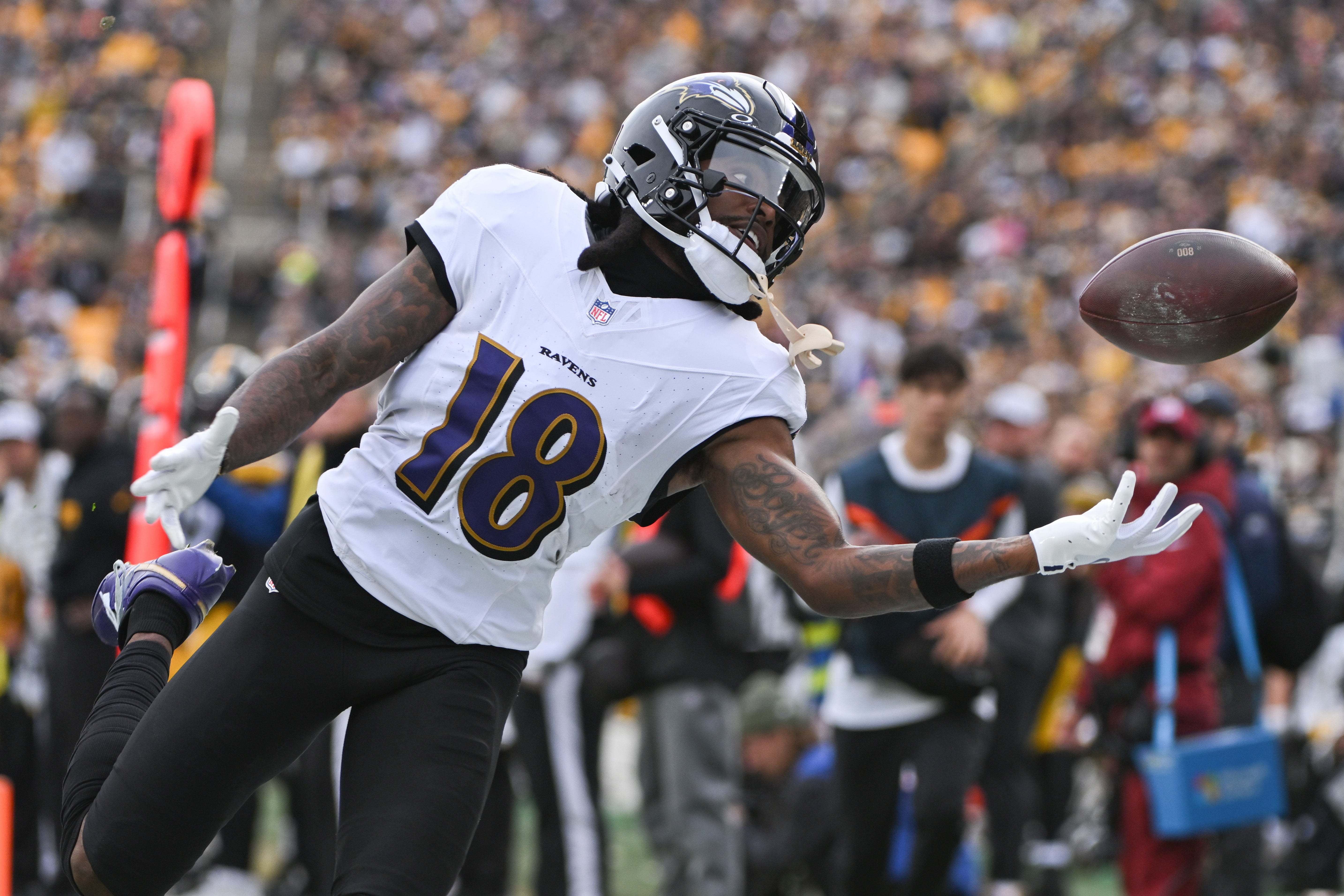 Nov 17, 2024; Pittsburgh, Pennsylvania, USA; Baltimore Ravens wide receiver Diontae Johnson (18) reaches for an incomplete pass against the Pittsburgh Steelers during the first quarter at Acrisure Stadium.