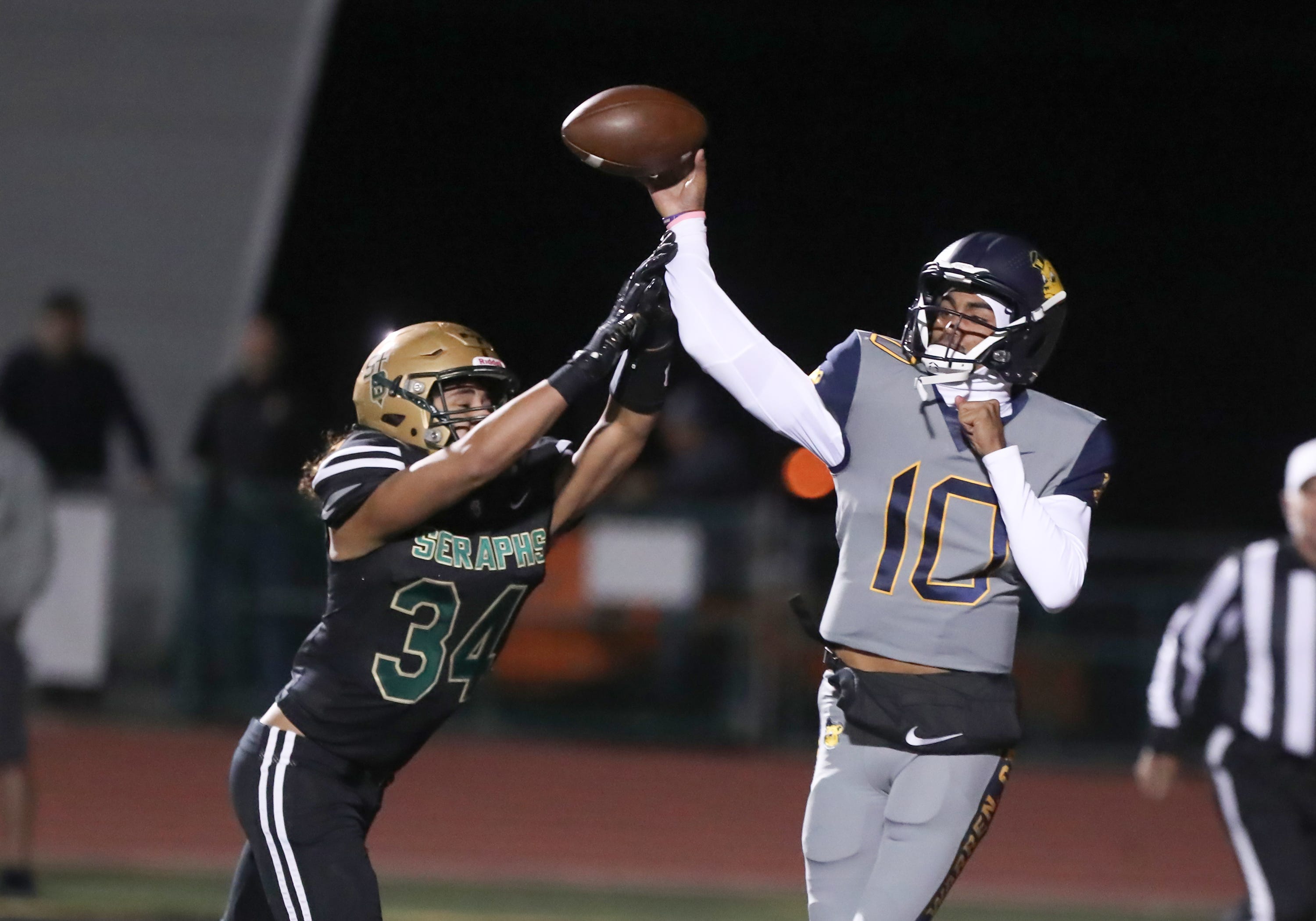 Warren quarterback Madden Iamaleava is under pressure by St. Bonaventure's Jacob Moraga as he fires a pass during the first quarter of the Seraphs' 24-21 win in the CIF-SS Division 3 championship game on Saturday, Nov. 25, 2023, at Ventura High's Larrabee Stadium.