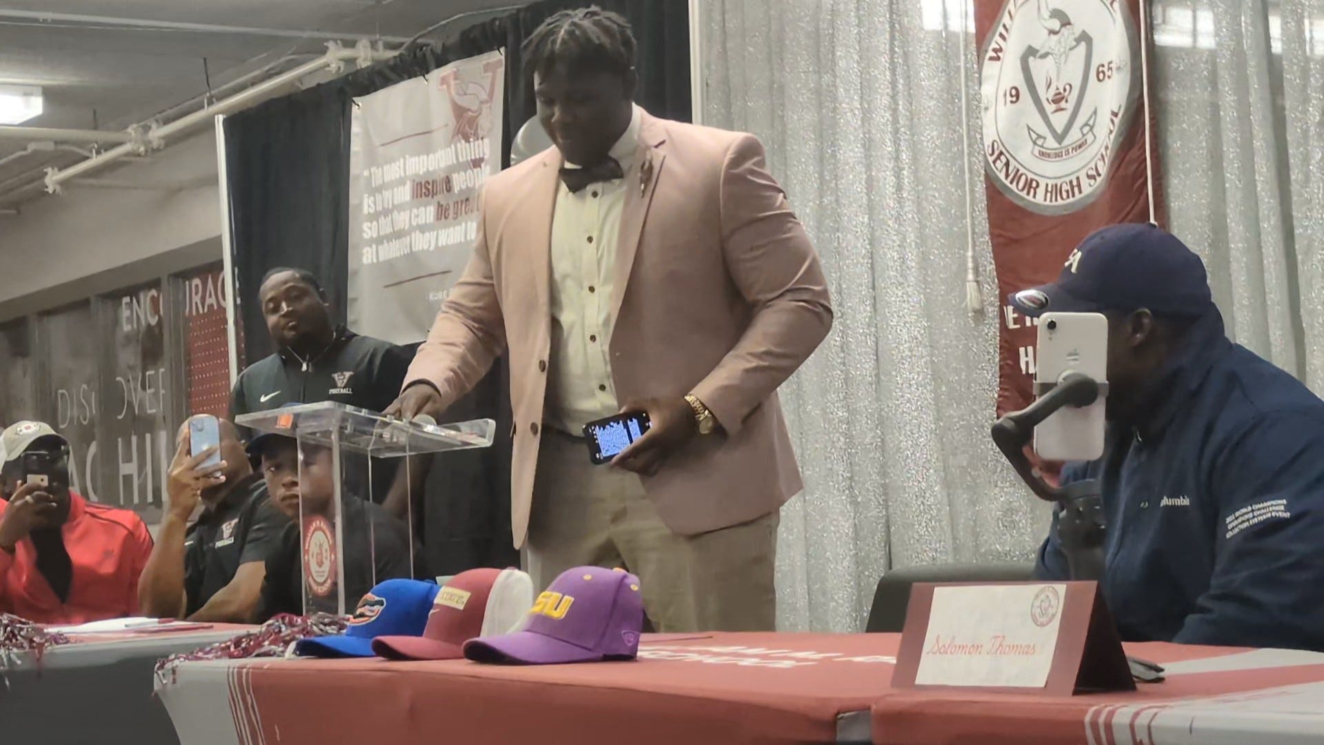 Raines offensive lineman Solomon Thomas prepares to choose from Florida, Florida State and LSU at his signing ceremony on Dec. 4, 2024.