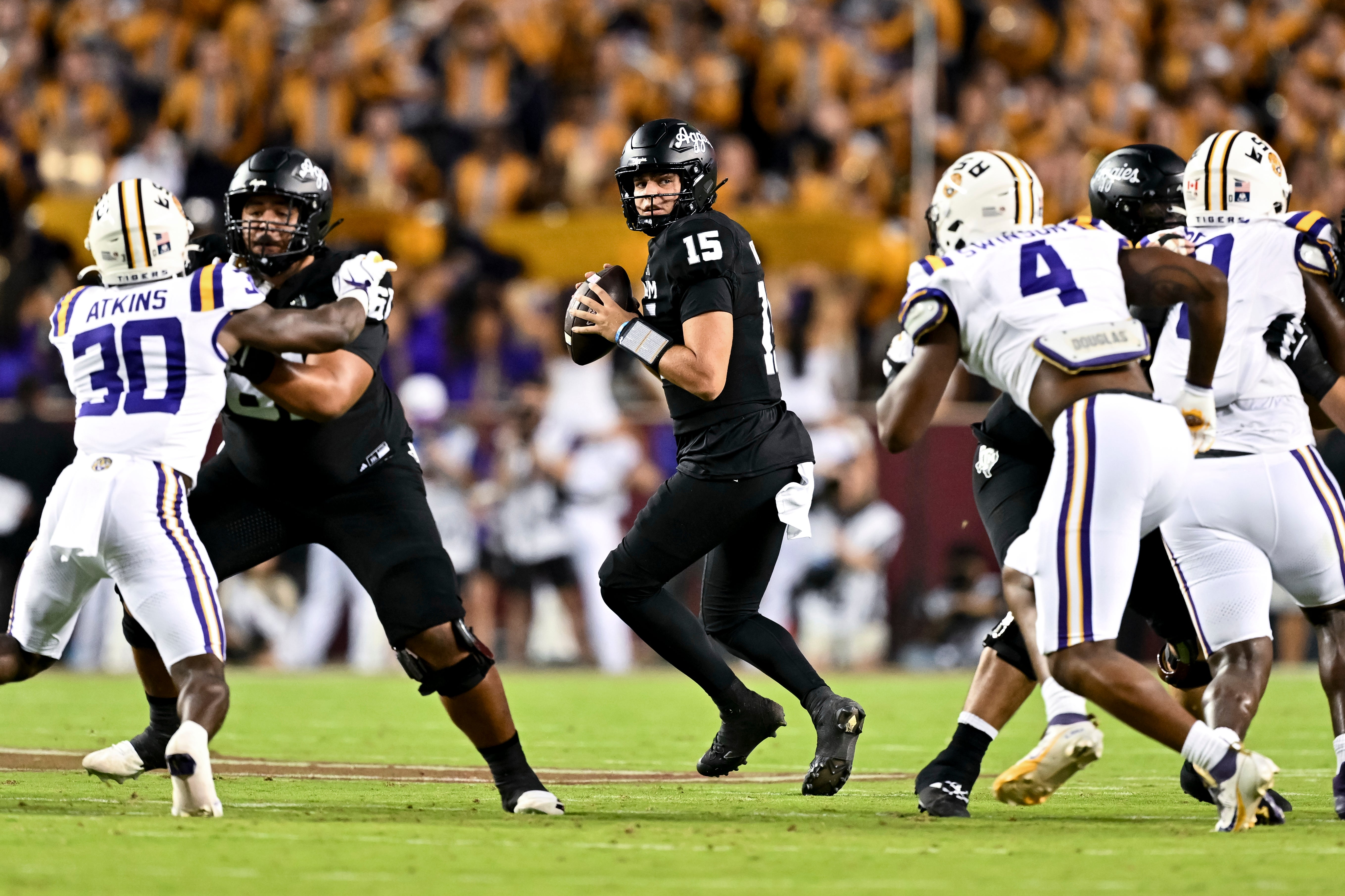Texas A&M Aggies quarterback Conner Weigman (15) looks to pass the ball during the first quarter against the LSU Tigers at Kyle Field.