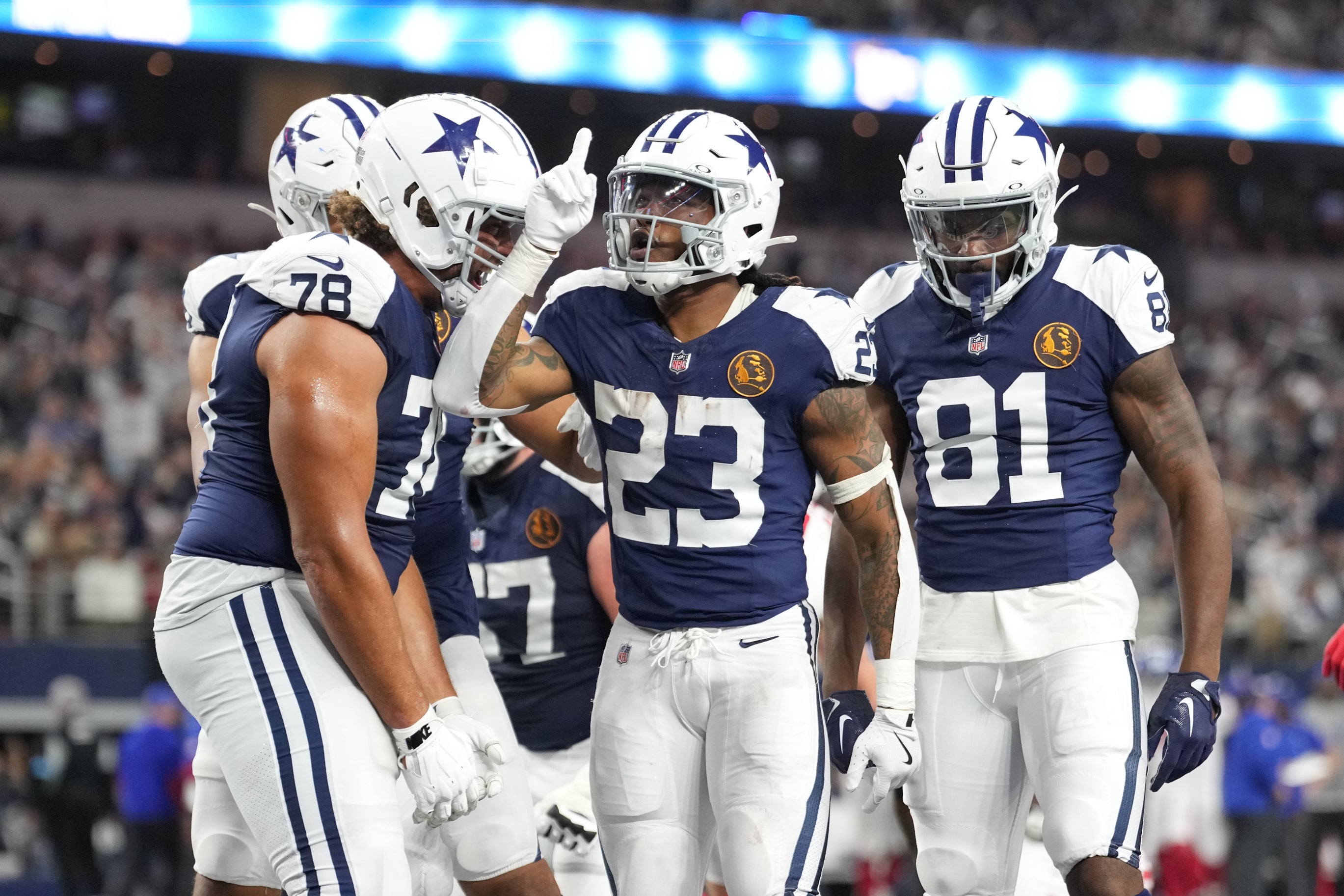 Dallas Cowboys running back Rico Dowdle (23) celebrates with teammates after scoring a touchdown against the New York Giants during the second half at AT&T Stadium.
