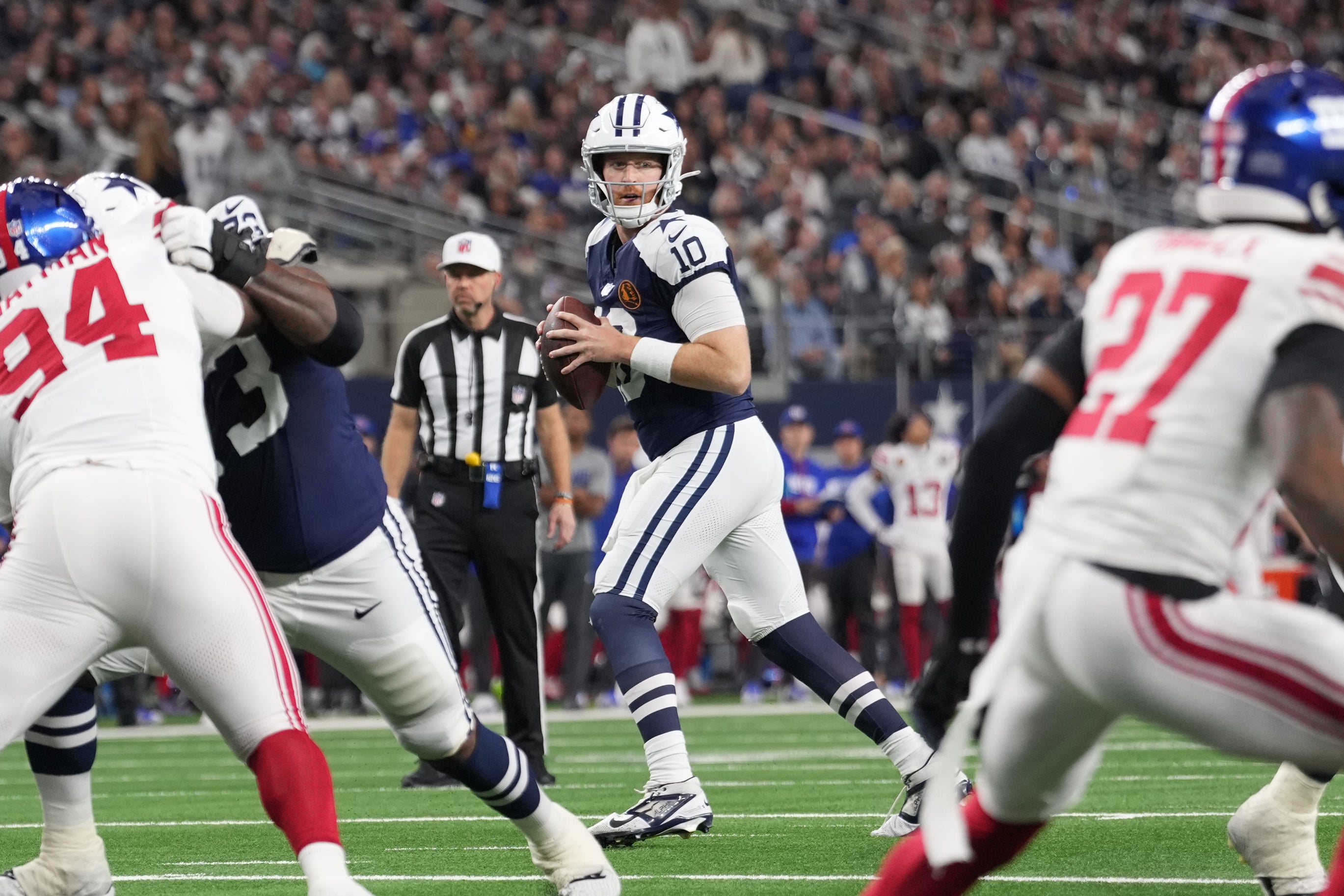 Dallas Cowboys quarterback Cooper Rush (10) looks to pass against the New York Giants during the first half at AT&T Stadium.