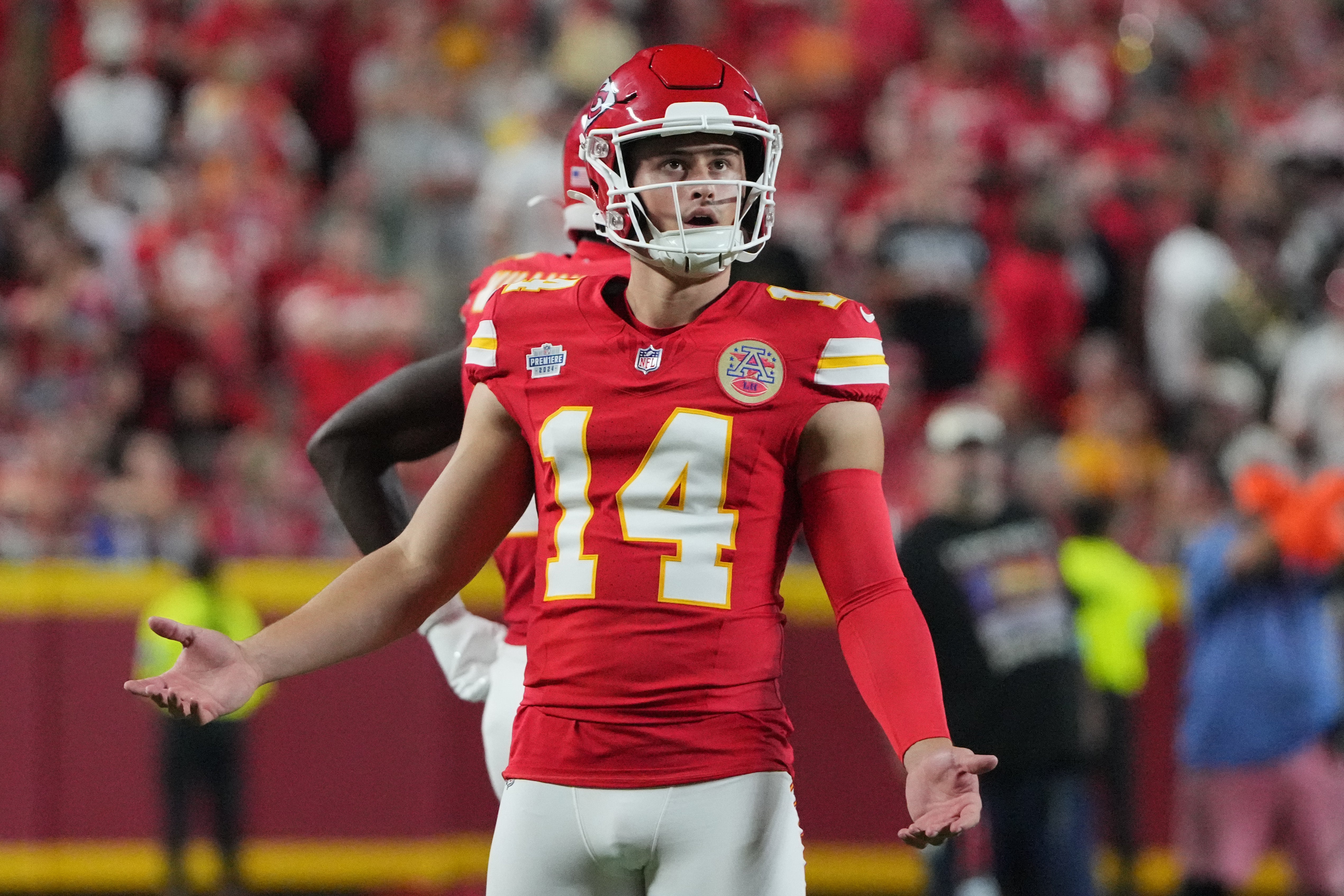 Kansas City Chiefs punter Matt Araiza (14) reacts while watching a replay against the Baltimore Ravens during the game at GEHA Field at Arrowhead Stadium.