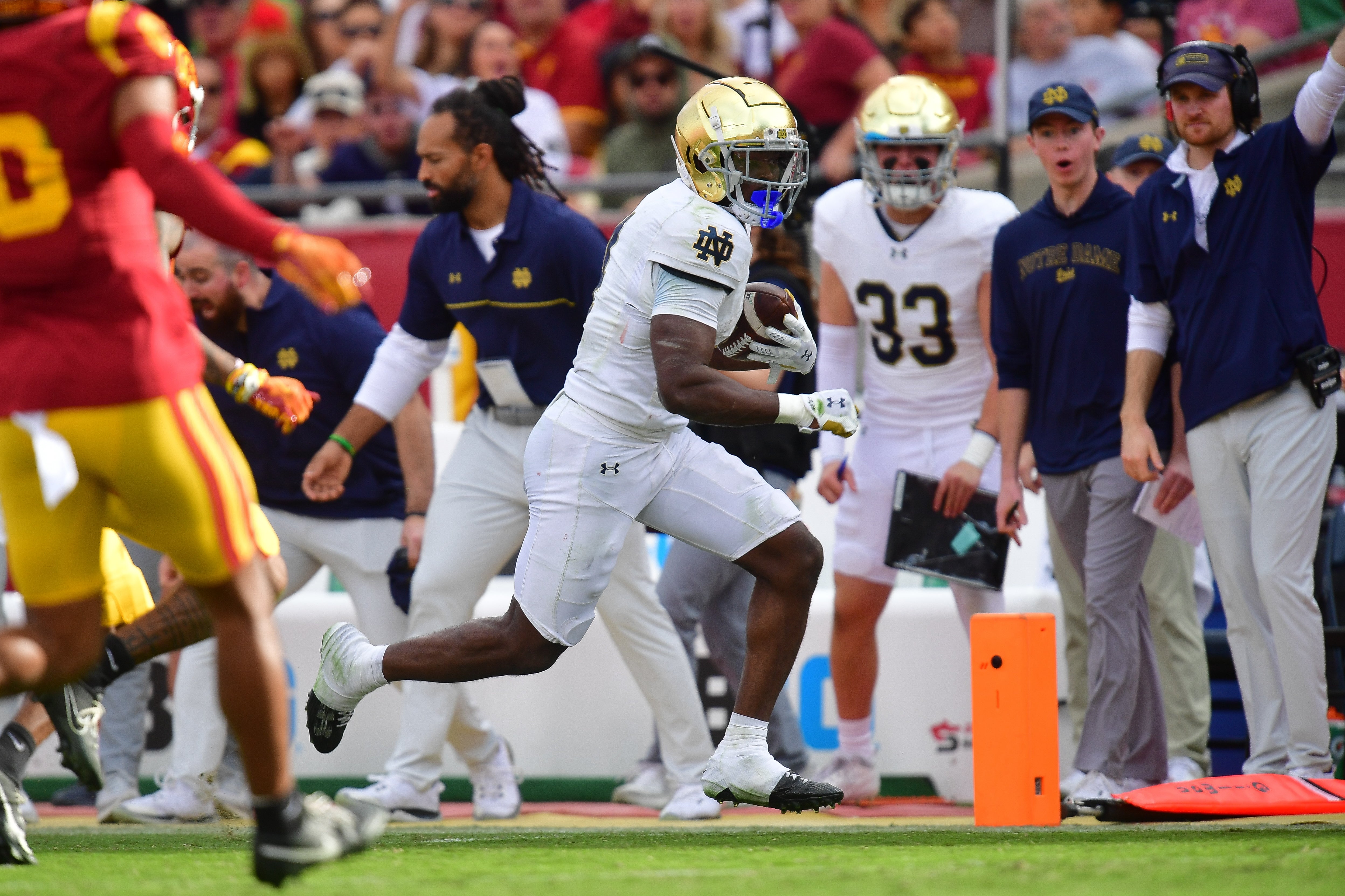 Notre Dame Fighting Irish running back Jeremiyah Love (4) runs the ball against the Southern California Trojans during the first half at the Los Angeles Memorial Coliseum.