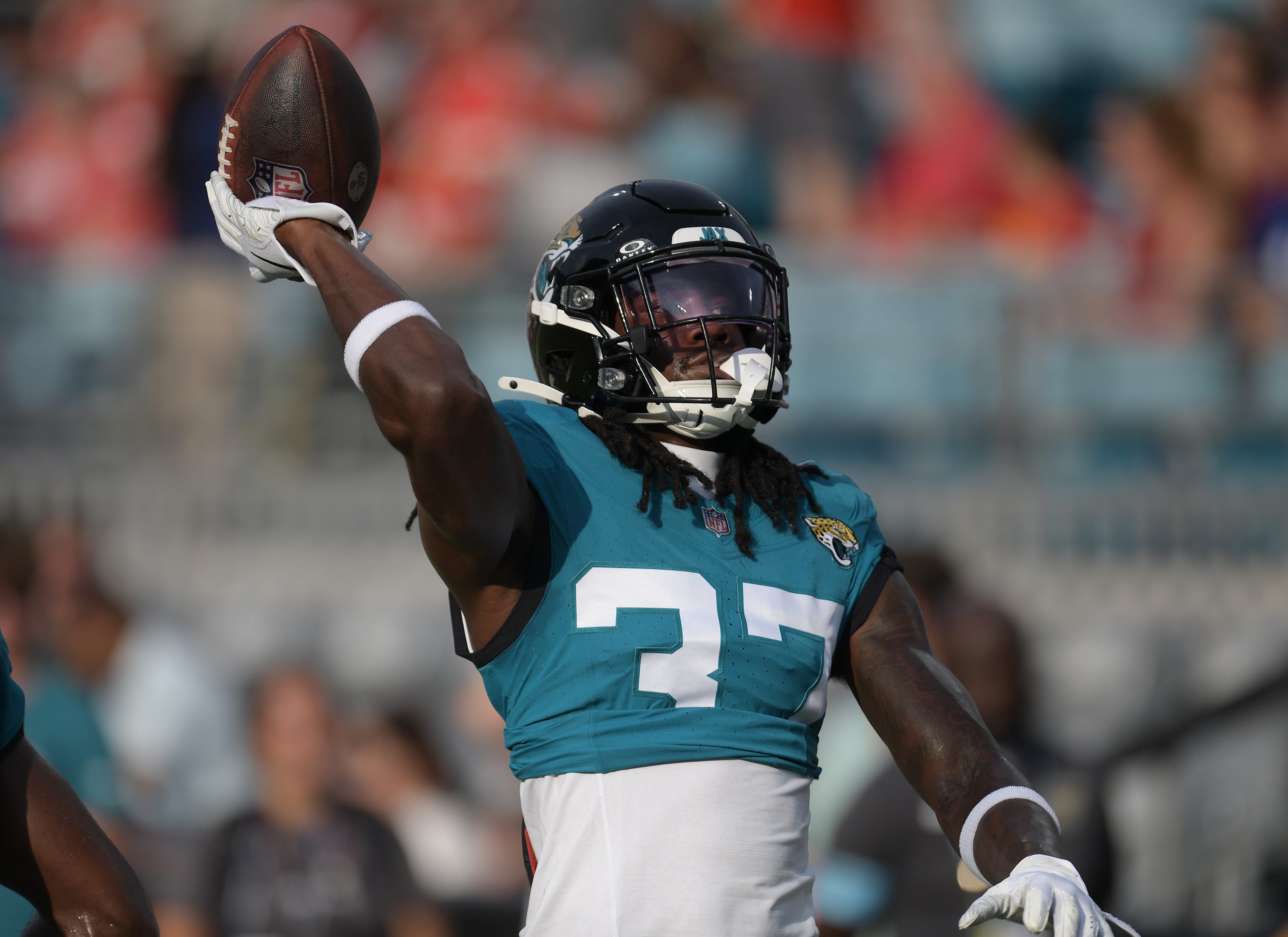 Jacksonville Jaguars cornerback Tre Flowers (37) throws the ball to fans in the stands as he warmed up ahead of the start of Saturday's game against the Chiefs. The Jaguars led 20 to 10 at the end of the first half. The Jacksonville Jaguars hosted the Kansas City Chiefs in the Jaguars first preseason game of the season Saturday, August10, 2024 at EverBank Stadium in Jacksonville, Fla.
