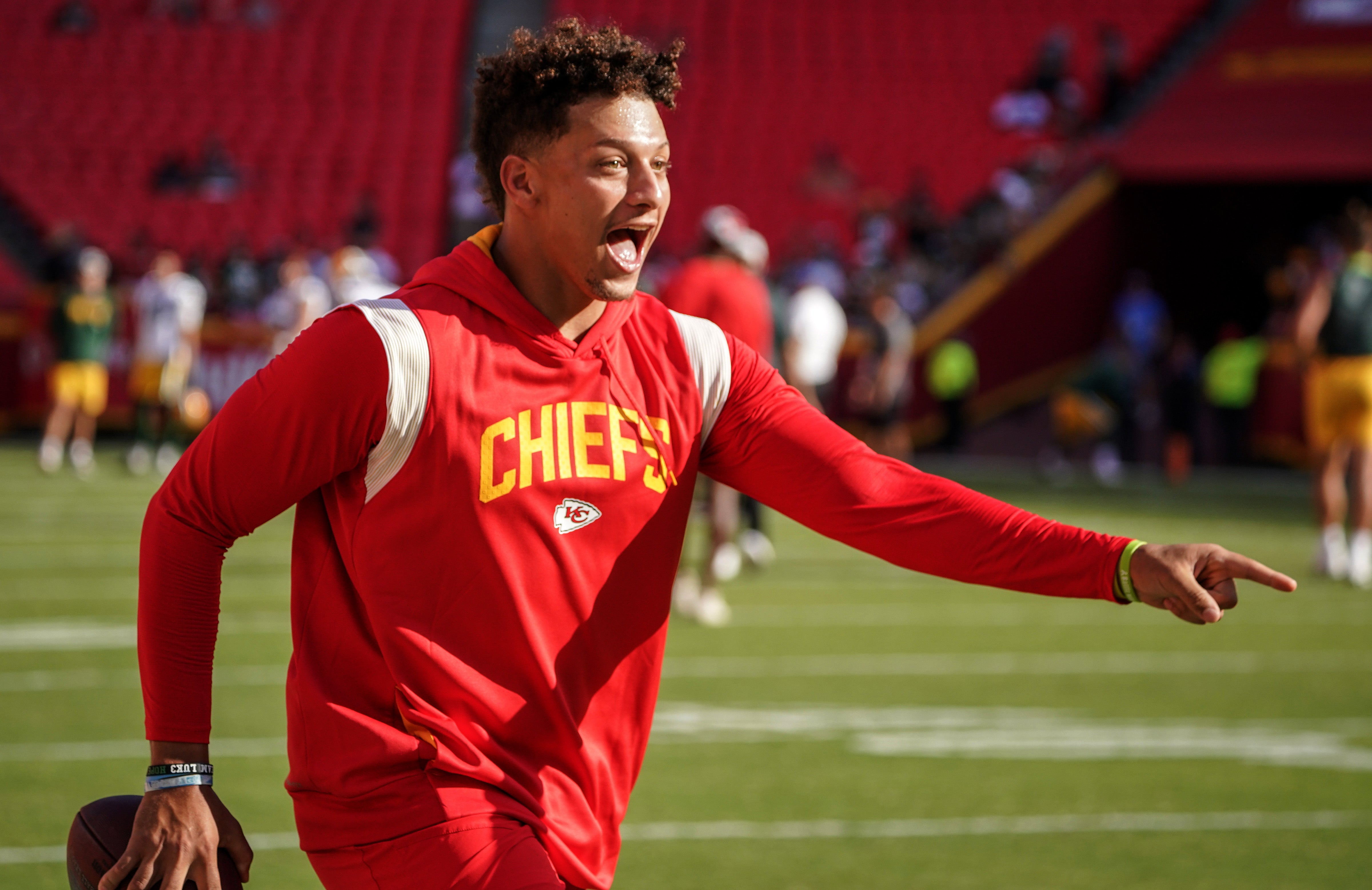 Aug 25, 2022; Kansas City, Missouri, USA; Kansas City Chiefs quarterback Patrick Mahomes (15) laughs after catching a pass over tight end Travis Kelce (not pictured) during warm ups before a preseason game against the Green Bay Packers at GEHA Field at Arrowhead Stadium.