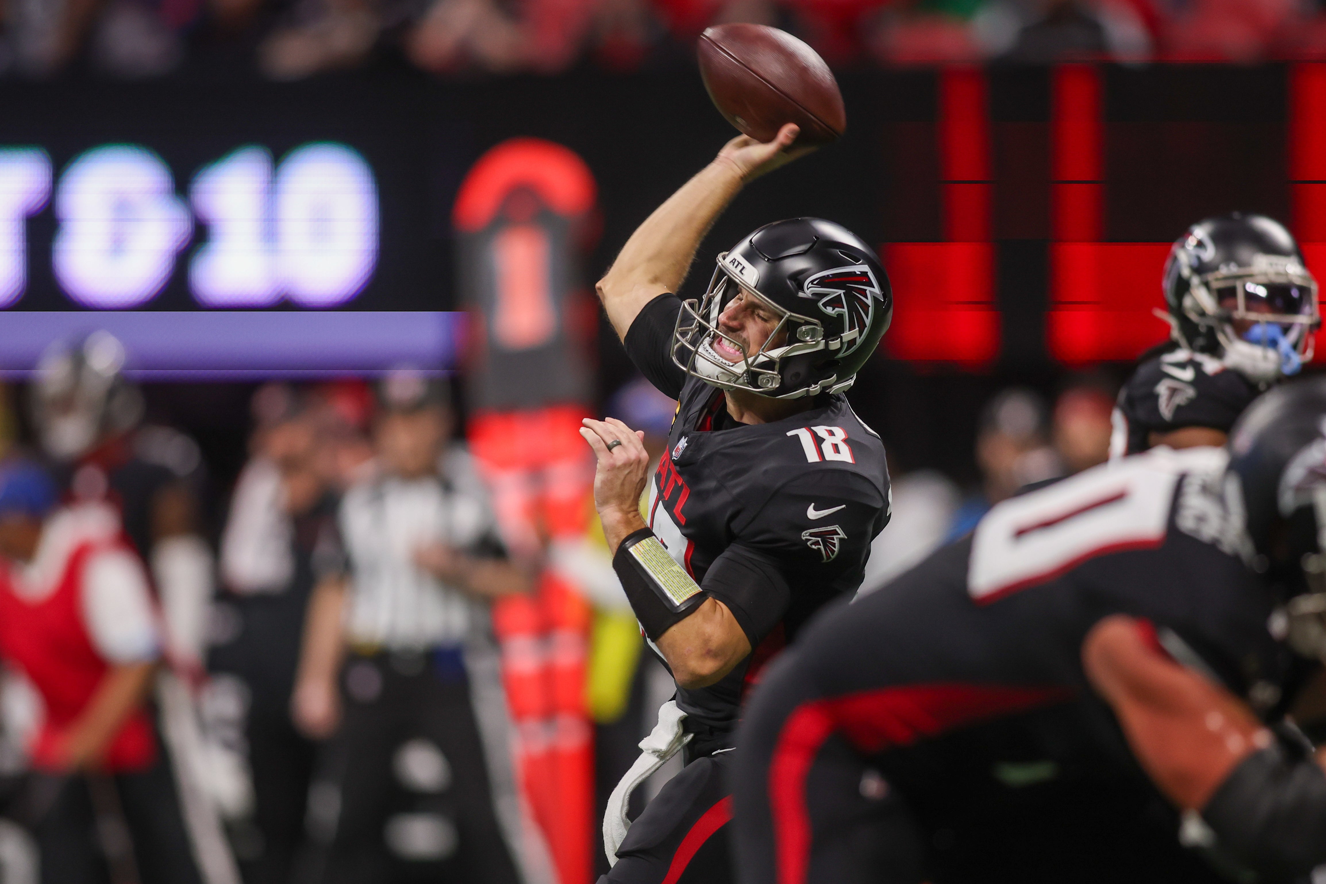 Dec 1, 2024; Atlanta, Georgia, USA; Atlanta Falcons quarterback Kirk Cousins (18) throws a pass against the Los Angeles Chargers in the third quarter at Mercedes-Benz Stadium.