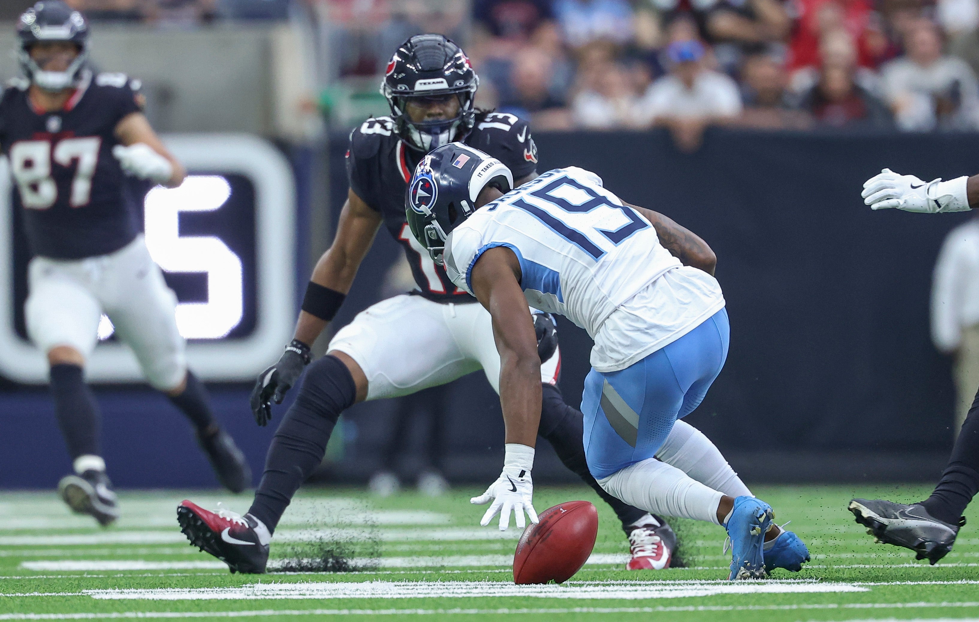 Nov 24, 2024; Houston, Texas, USA; Tennessee Titans wide receiver Jha'Quan Jackson (19) fumbles a punt during the fourth quarter against the Houston Texans at NRG Stadium. Mandatory Credit: Troy Taormina-Imagn Images