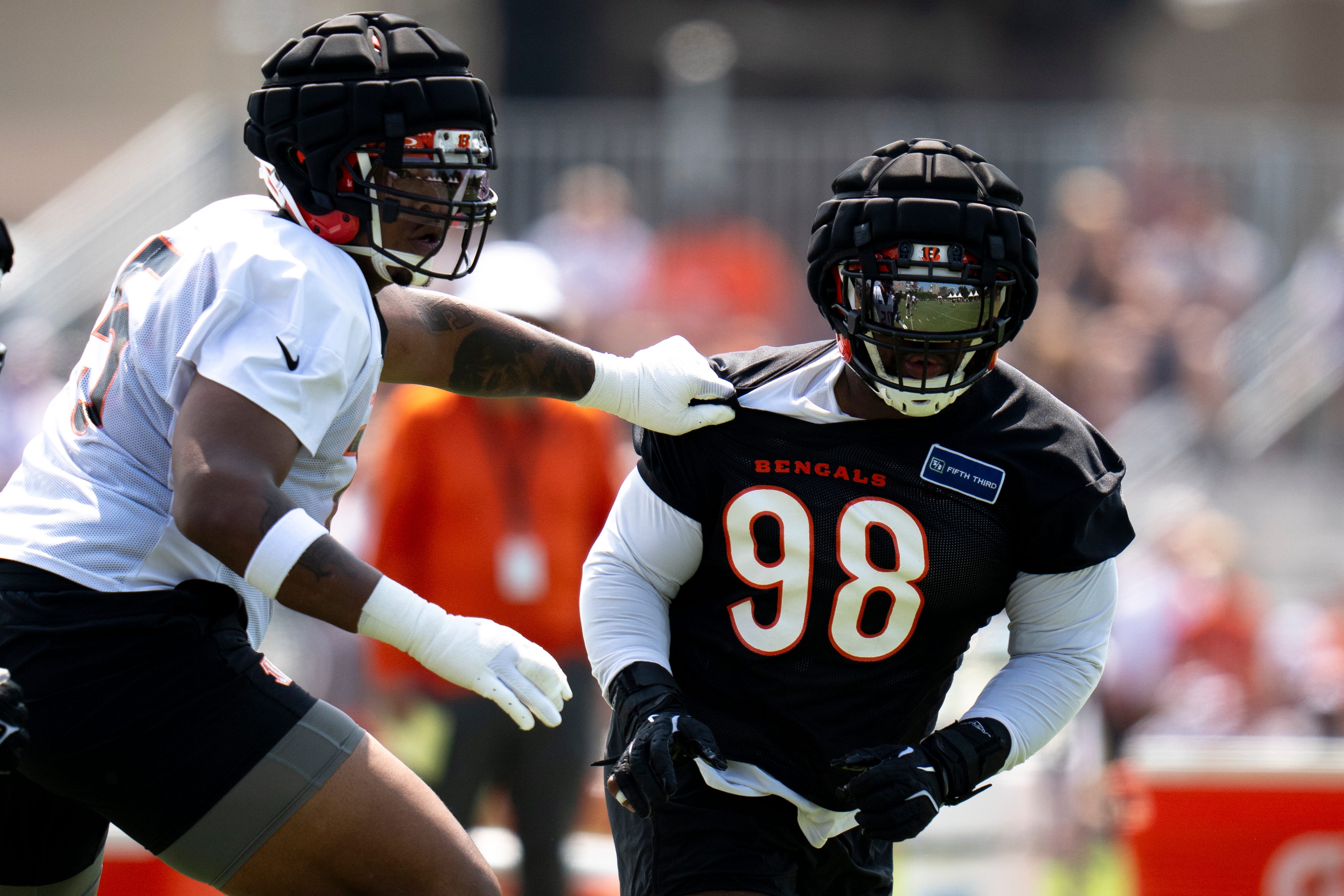 Cincinnati Bengals defensive tackle Sheldon Rankins (98) is blocked by Cincinnati Bengals offensive tackle Orlando Brown Jr. (75) during Cincinnati Bengals training camp in Cincinnati on Friday, July 26, 2024.