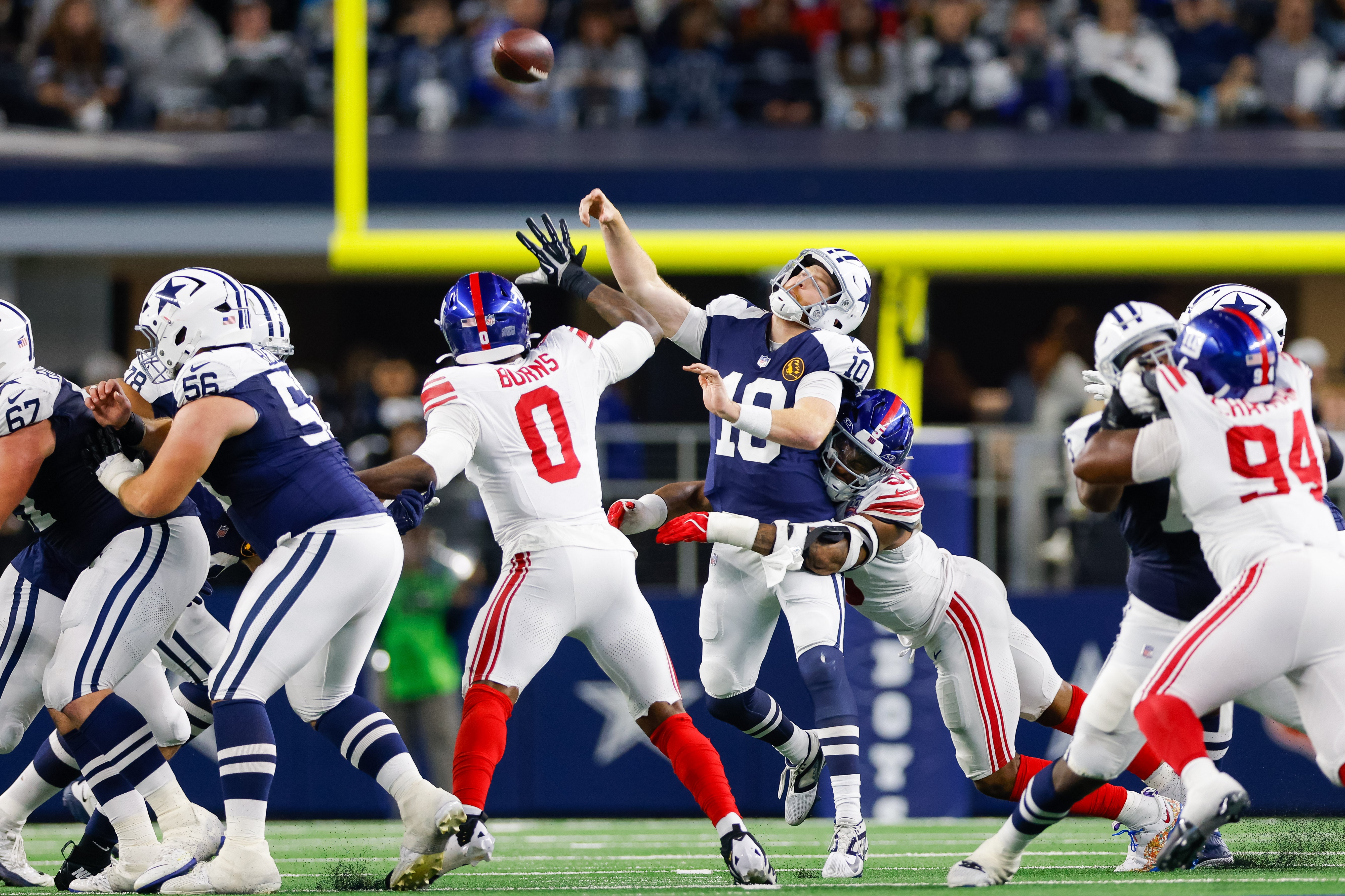 Dallas Cowboys quarterback Cooper Rush (10) is hit by New York Giants linebacker Kayvon Thibodeaux (5) while making a pass during the second quarter at AT&T Stadium.