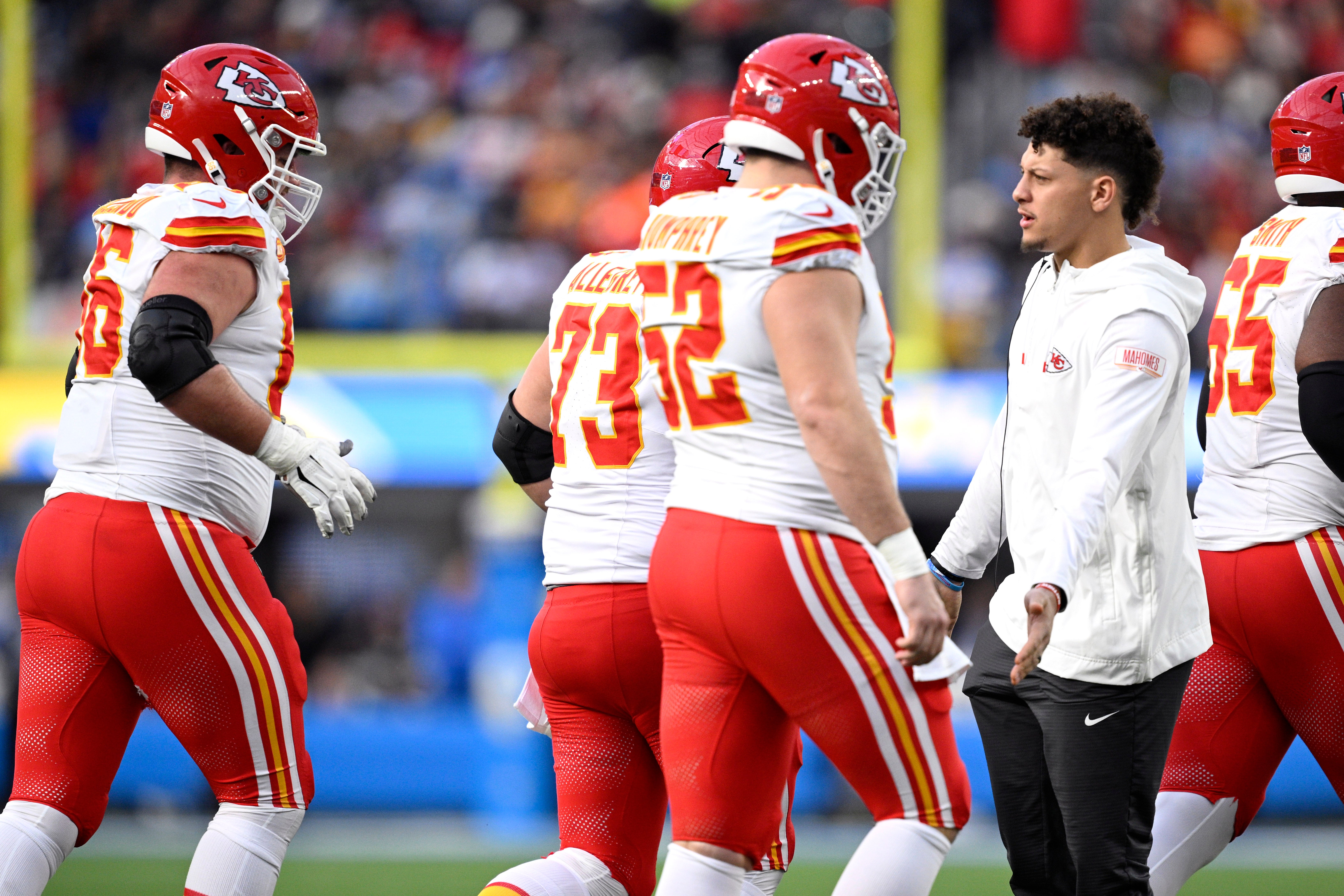 Jan 7, 2024; Inglewood, California, USA; Kansas City Chiefs quarterback Patrick Mahomes (right) greets teammates on the sideline during the first half against the Los Angeles Chargers at SoFi Stadium.