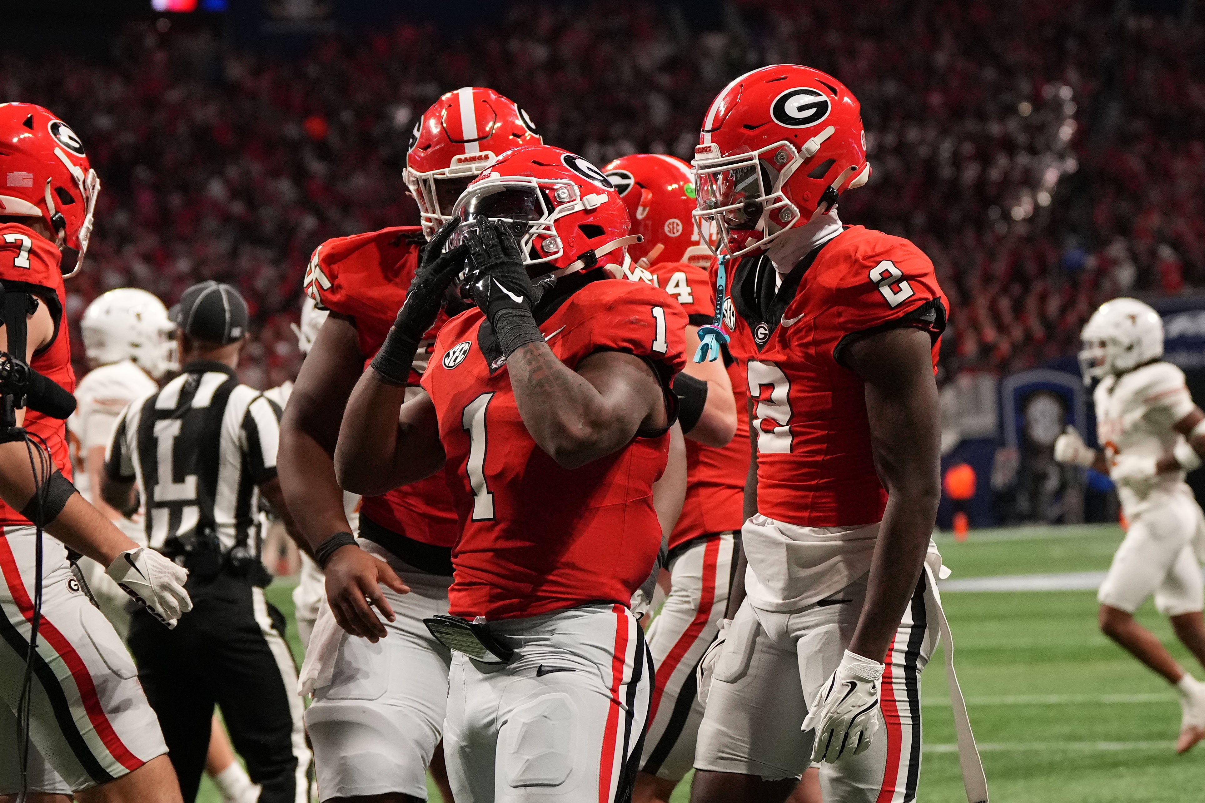 Georgia Bulldogs running back Trevor Etienne (1) reacts after rushing for a touchdown against the Texas Longhorns during the second half in the 2024 SEC Championship game at Mercedes-Benz Stadium.