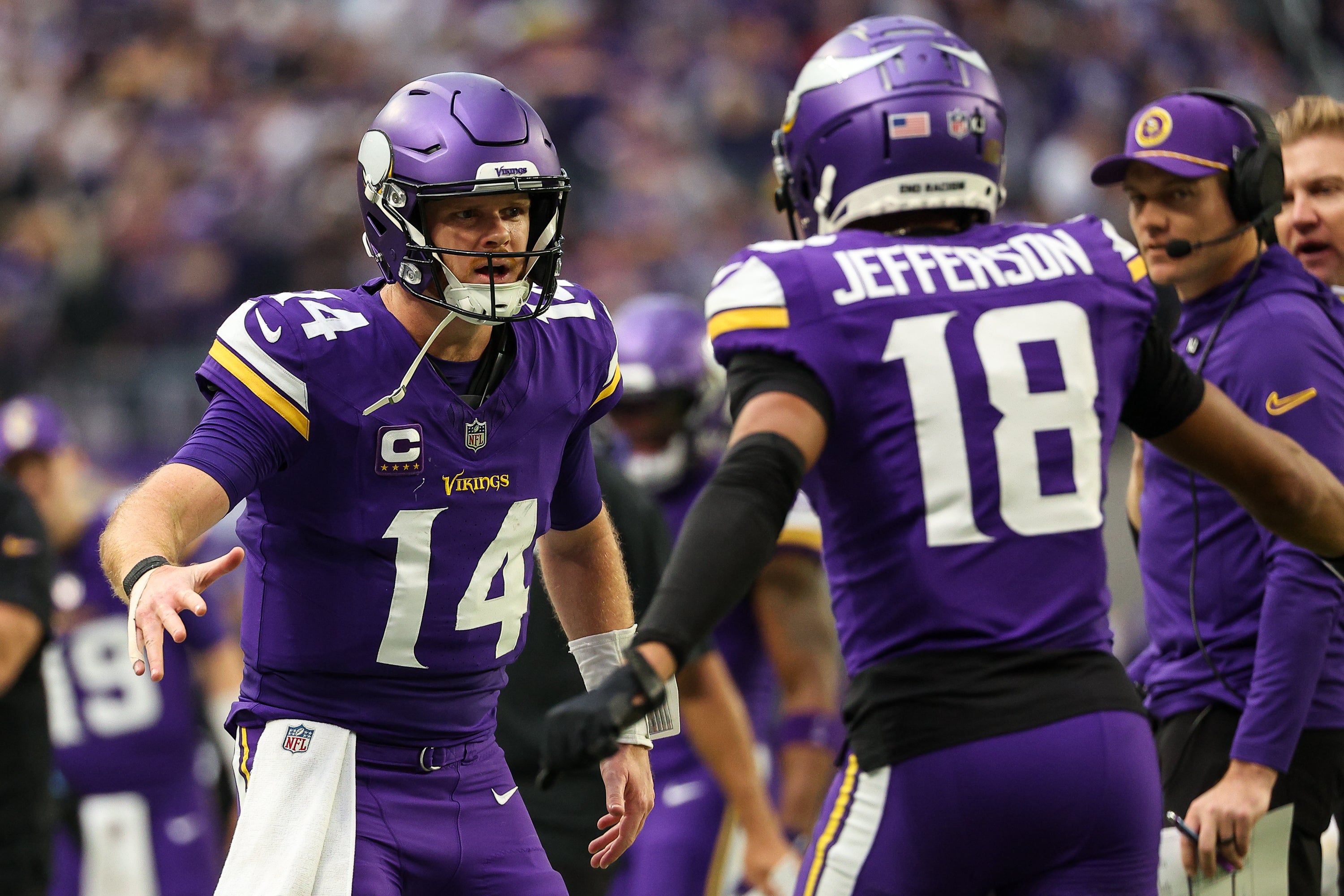 Dec 8, 2024; Minneapolis, Minnesota, USA; Minnesota Vikings quarterback Sam Darnold (14) celebrates his touchdown pass to wide receiver Justin Jefferson (18) against the Atlanta Falcons during the second quarter at U.S. Bank Stadium.