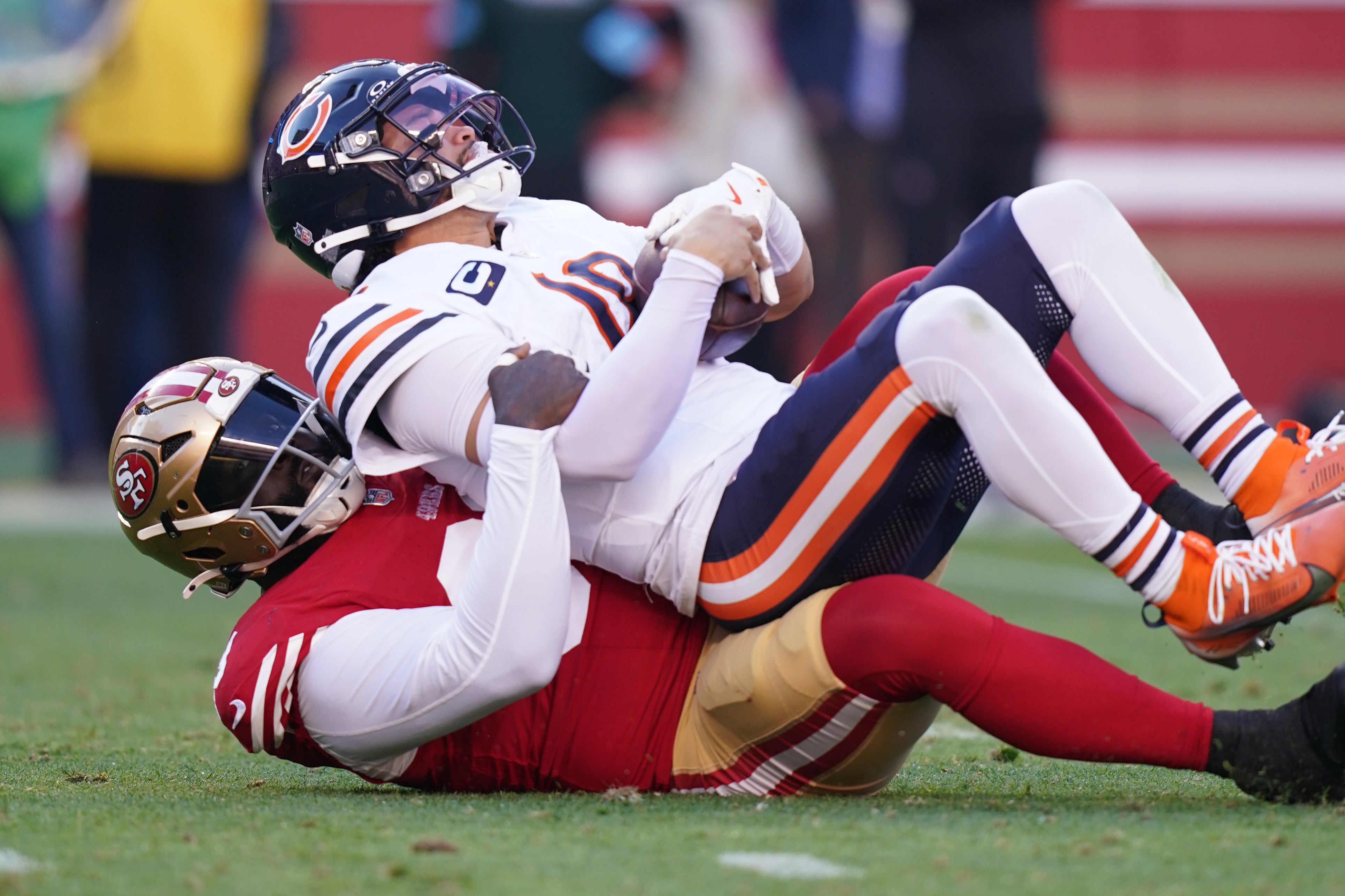 Dec 8, 2024; Santa Clara, California, USA; Chicago Bears quarterback Caleb Williams (18) is sacked by San Francisco 49ers defensive tackle Maliek Collins (99) in the second quarter at Levi's Stadium.
