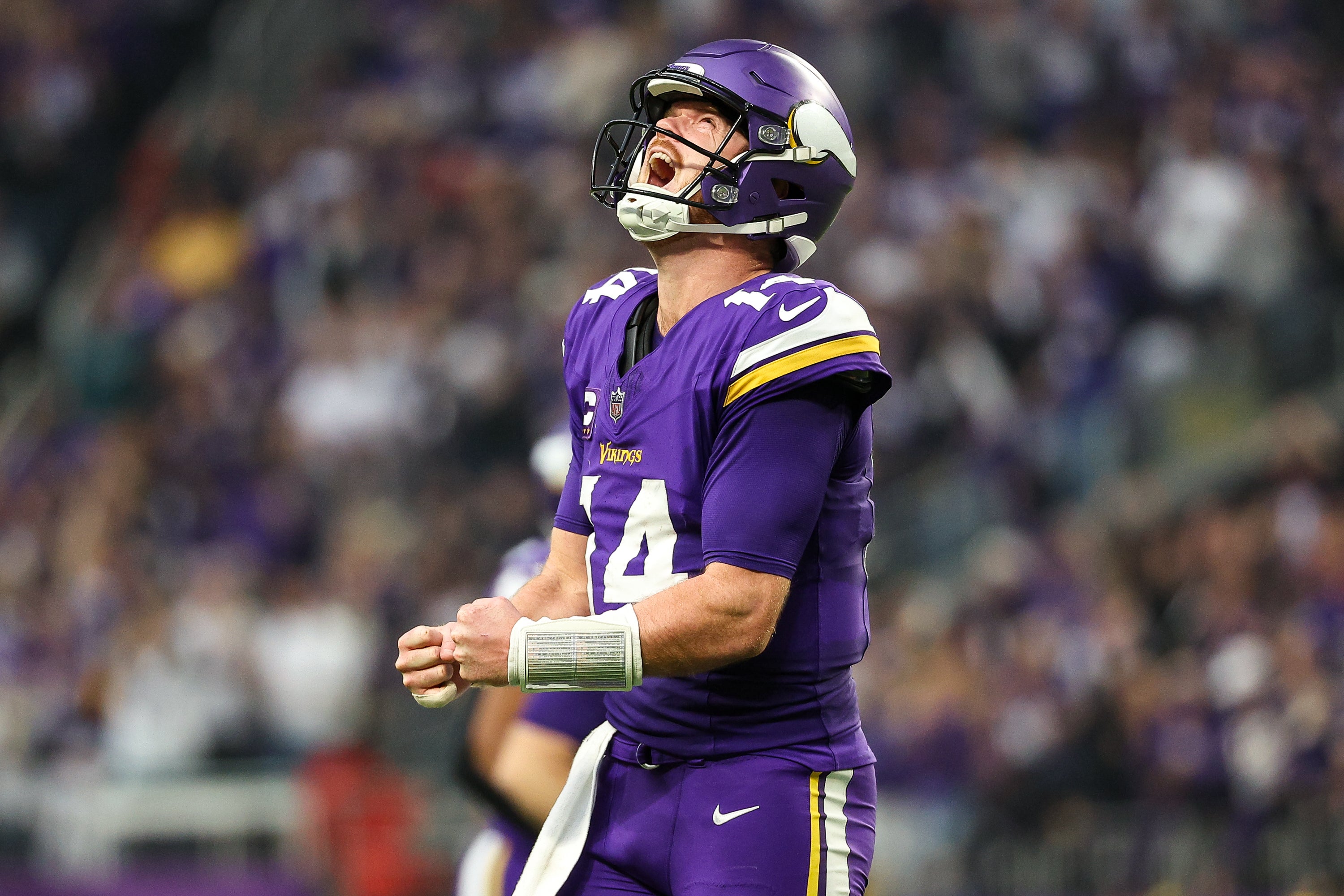 Dec 8, 2024; Minneapolis, Minnesota, USA; Minnesota Vikings quarterback Sam Darnold (14) celebrates his touchdown to wide receiver Jordan Addison (3) during the fourth quarter against the Atlanta Falcons at U.S. Bank Stadium.