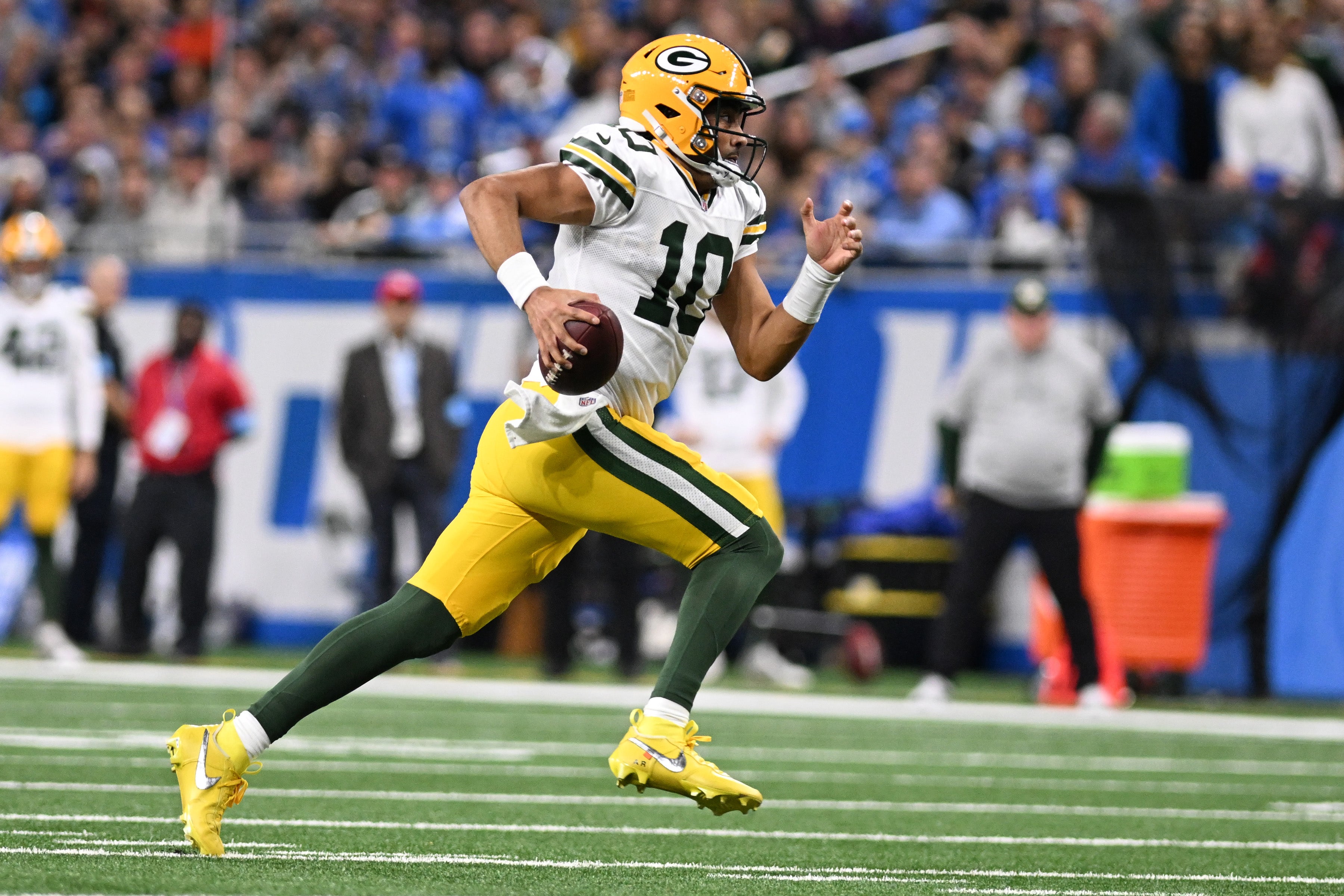 Green Bay Packers quarterback Jordan Love (10) scrambles for a first down against the Detroit Lions in the second quarter at Ford Field.