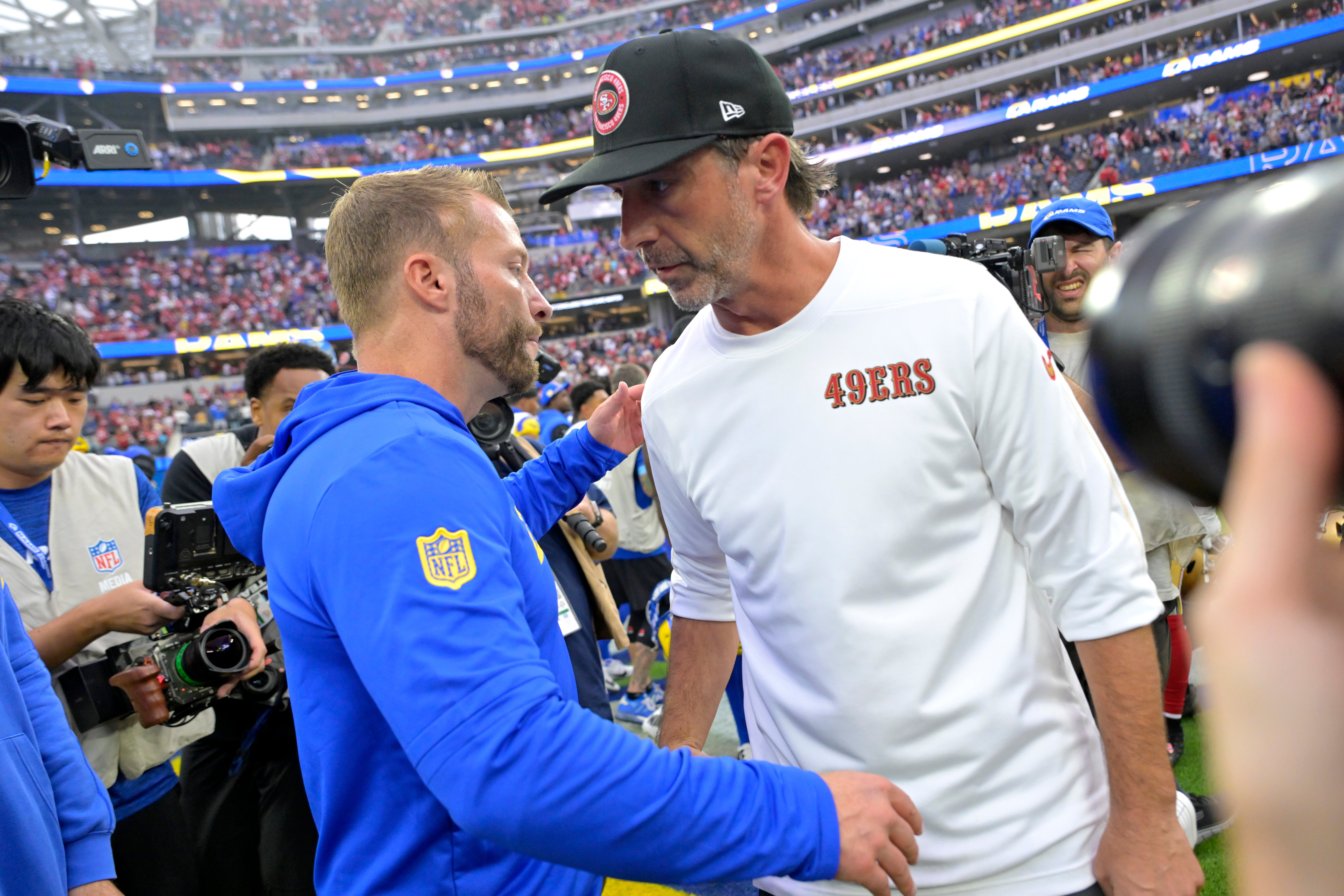 Los Angeles Rams head coach Sean McVay and San Francisco 49ers head coach Kyle Shanahan meet on the field following the game at SoFi Stadium.