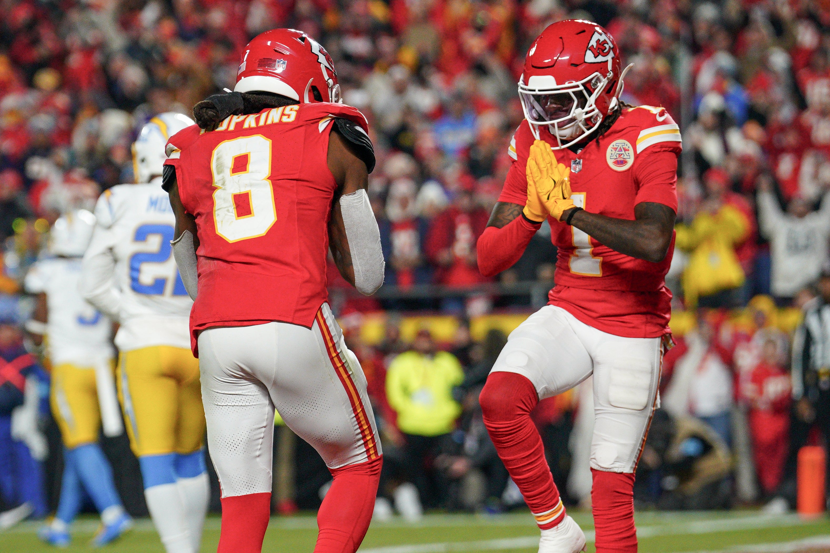 Chiefs wide receiver DeAndre Hopkins (8) celebrates with wide receiver Xavier Worthy (1) after scoring against the Chargers.
