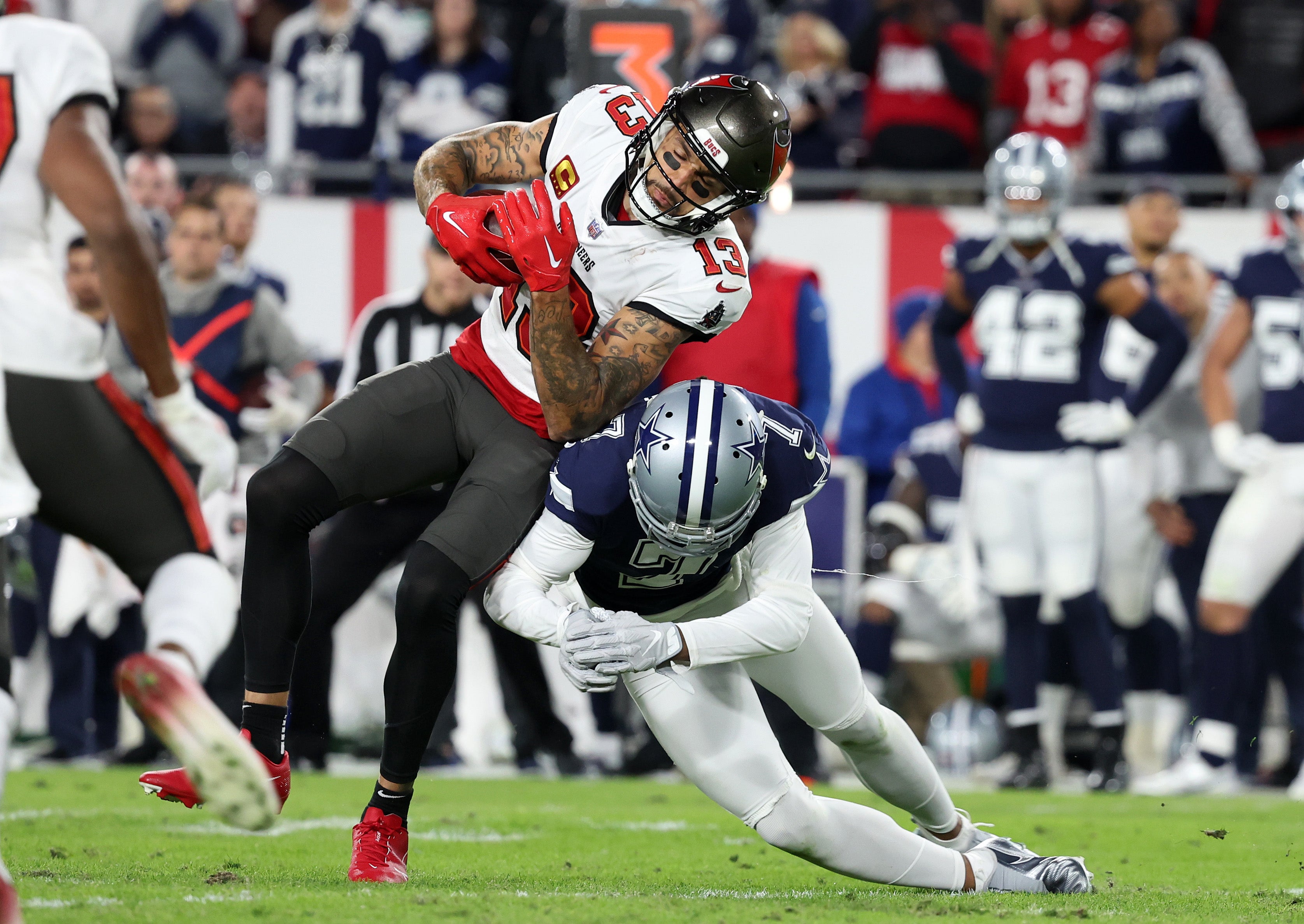 Tampa Bay Buccaneers wide receiver Mike Evans (13) makes a catch against Dallas Cowboys cornerback Trevon Diggs (7) in the first half during the wild card game at Raymond James Stadium.