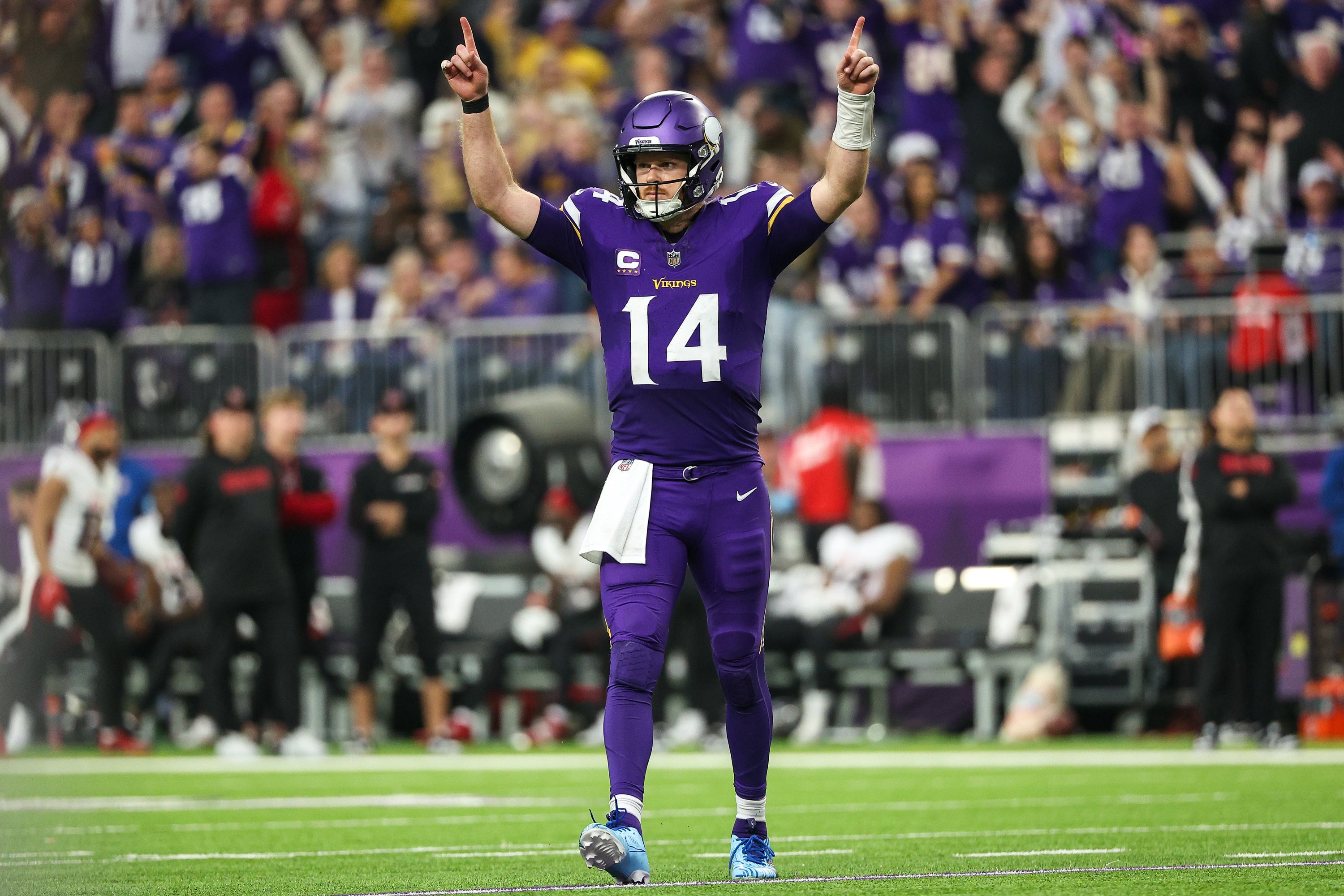 Dec 8, 2024; Minneapolis, Minnesota, USA; Minnesota Vikings quarterback Sam Darnold (14) celebrates running back Aaron Jones' (33) touchdown run against the Atlanta Falcons during the fourth quarter at U.S. Bank Stadium.