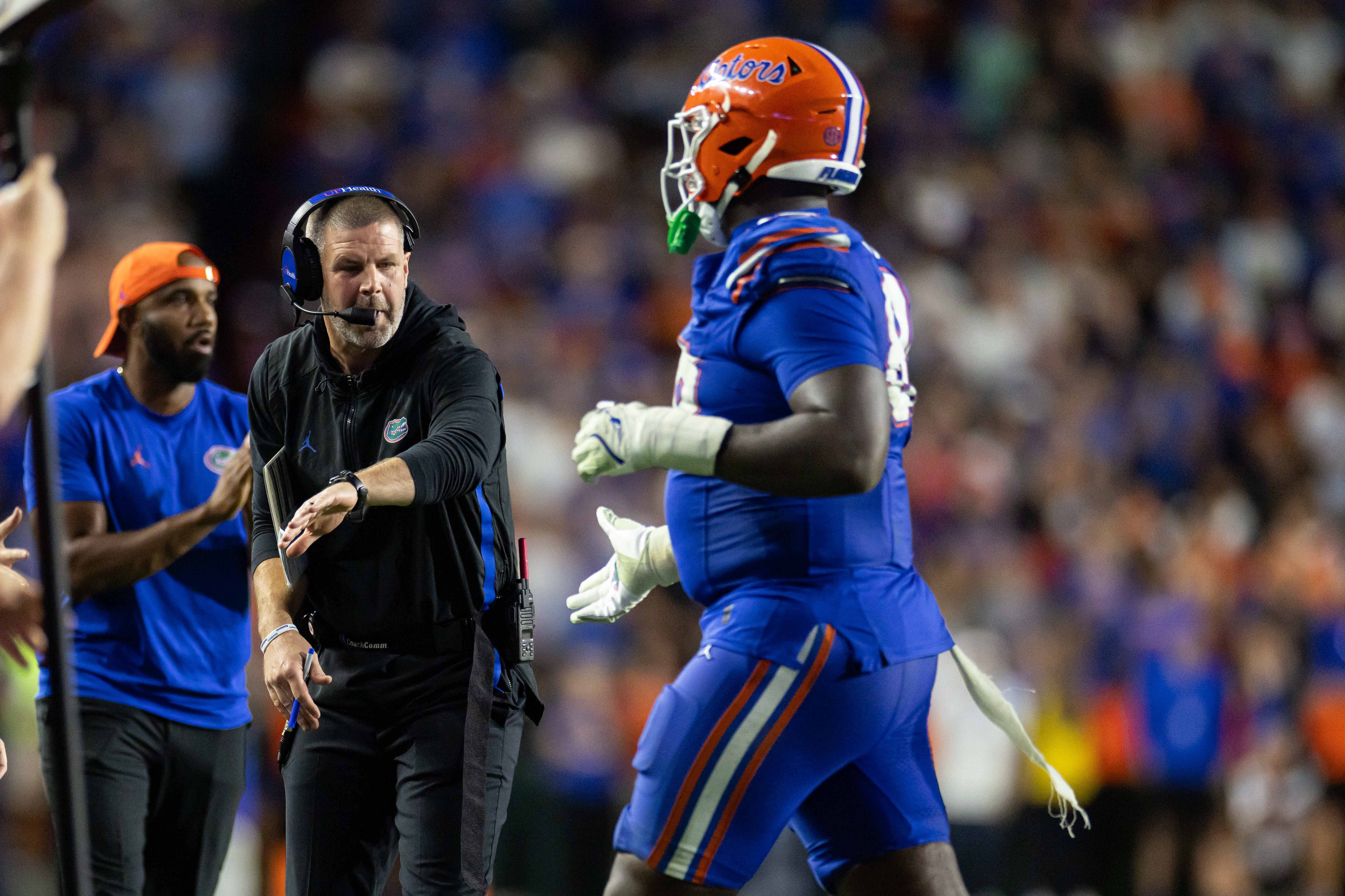 Nov 16, 2024; Gainesville, Florida, USA; Florida Gators head coach Billy Napier gestures towards Florida Gators defensive lineman Caleb Banks (88) against the LSU Tigers during the second half at Ben Hill Griffin Stadium.
