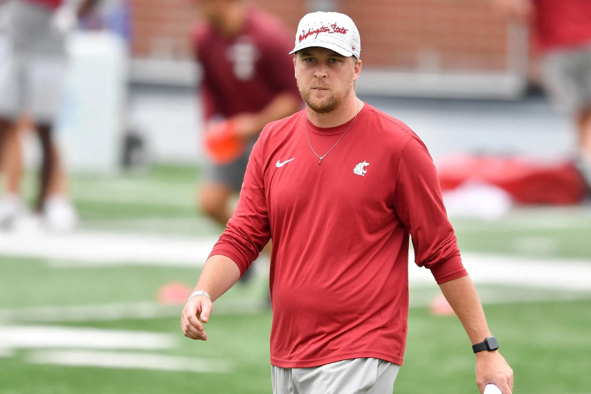 WSU offensive coordinator Ben Arbuckle watches his players during a fall camp practice, Aug. 9, 2023, at Martin Stadium in Pullman, Wash.