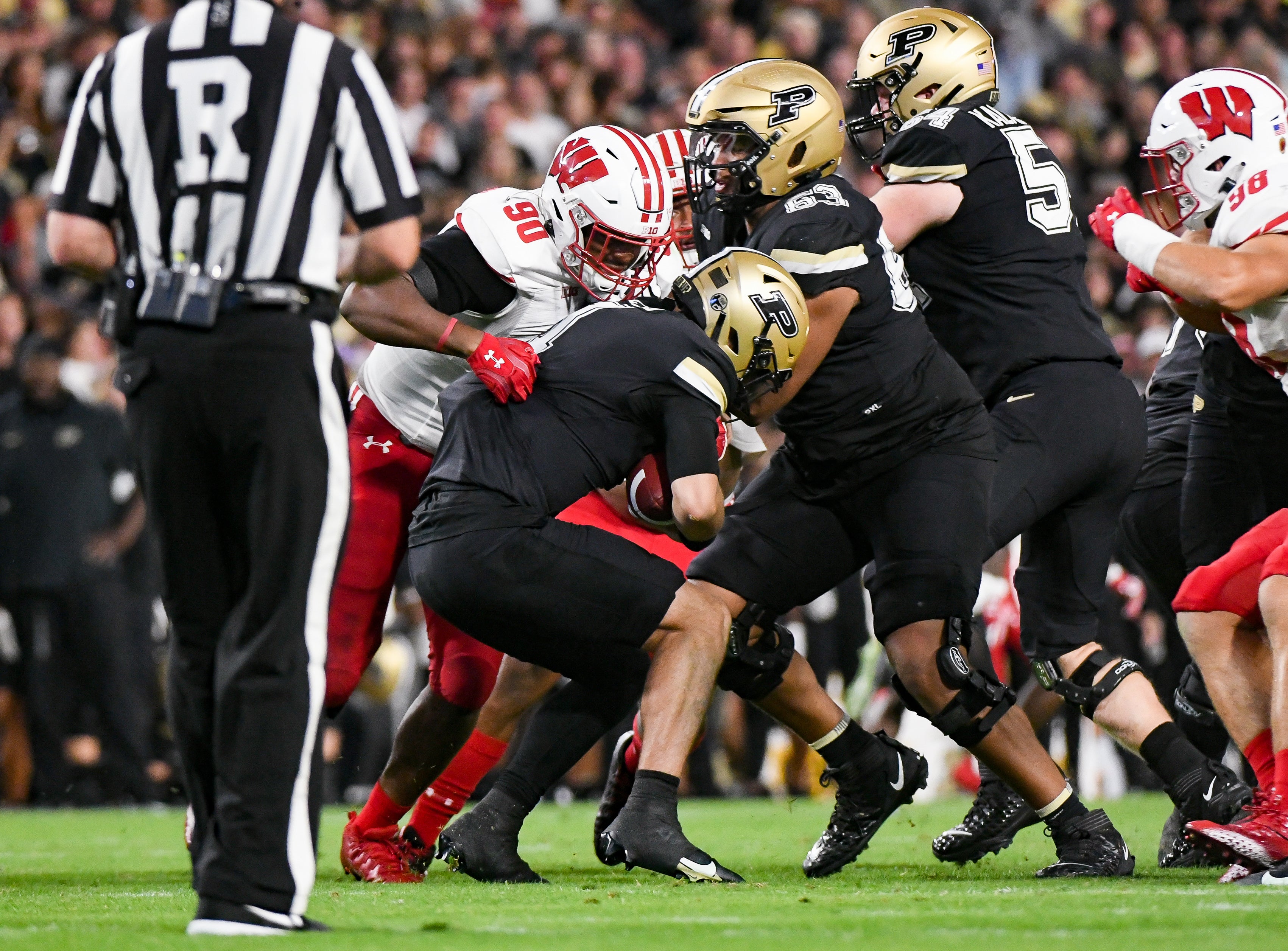 Wisconsin Badgers defensive end James Thompson Jr. (90) sacks Purdue Boilermakers quarterback Hudson Card (1) during the first half at Ross-Ade Stadium.