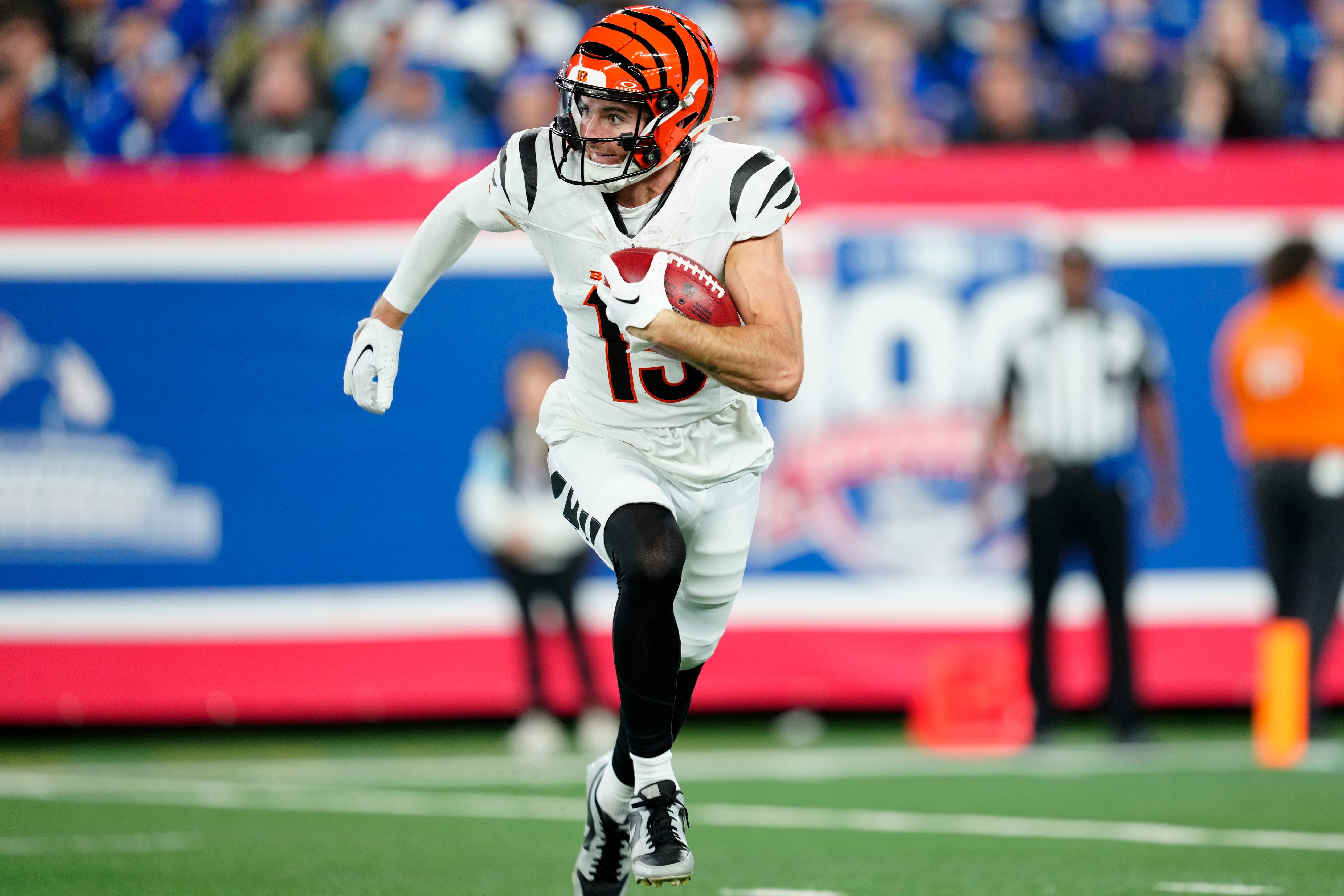 Cincinnati Bengals wide receiver Charlie Jones (15) runs with the ball after catching a punt, Sunday, October 13, 2024, in East Rutherford.