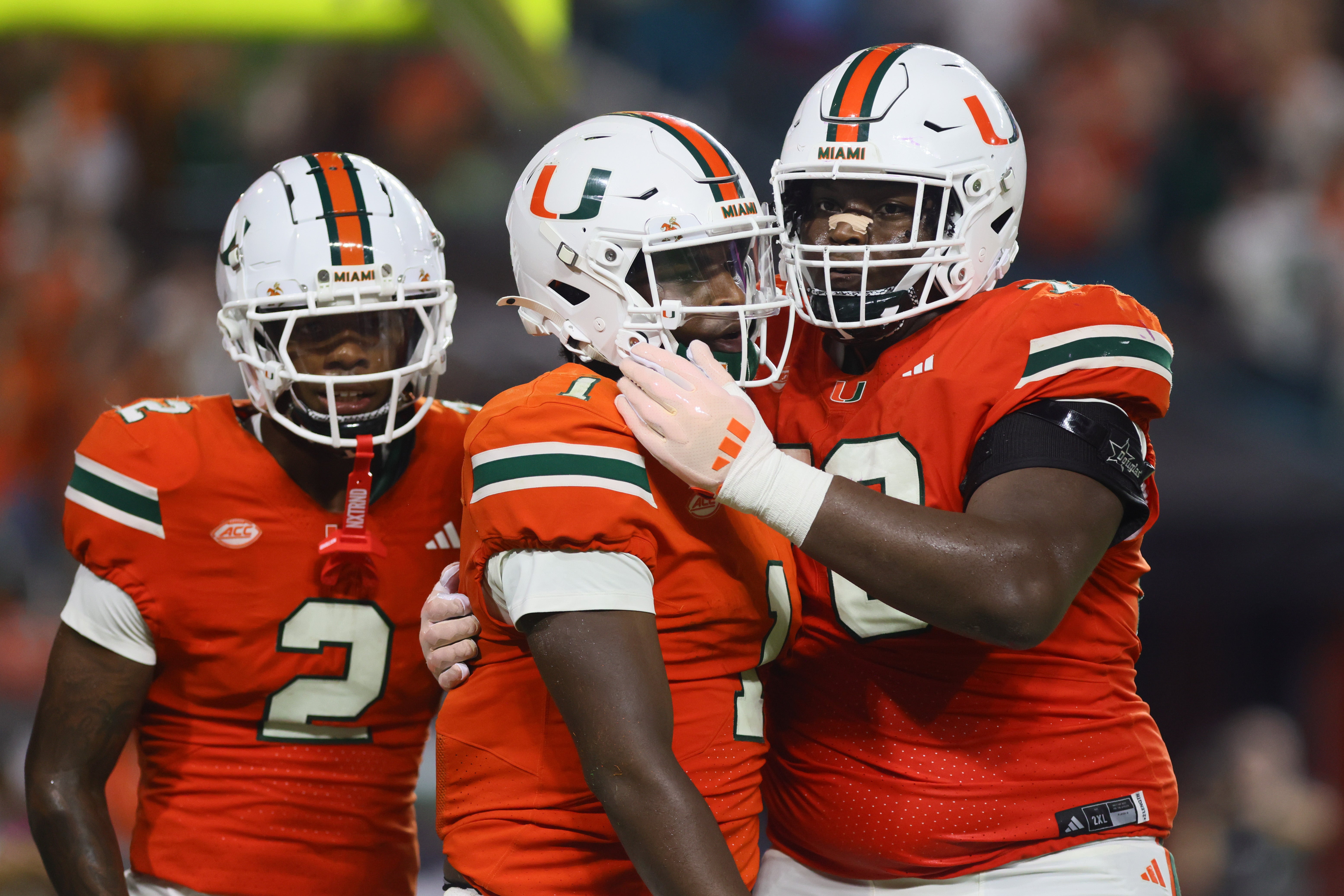 Sep 27, 2024; Miami Gardens, Florida, USA; Miami Hurricanes quarterback Cam Ward (1) celebrates with offensive lineman Taylor Broutin (72) after a touchdown against the Virginia Tech Hokies during the third quarter at Hard Rock Stadium.