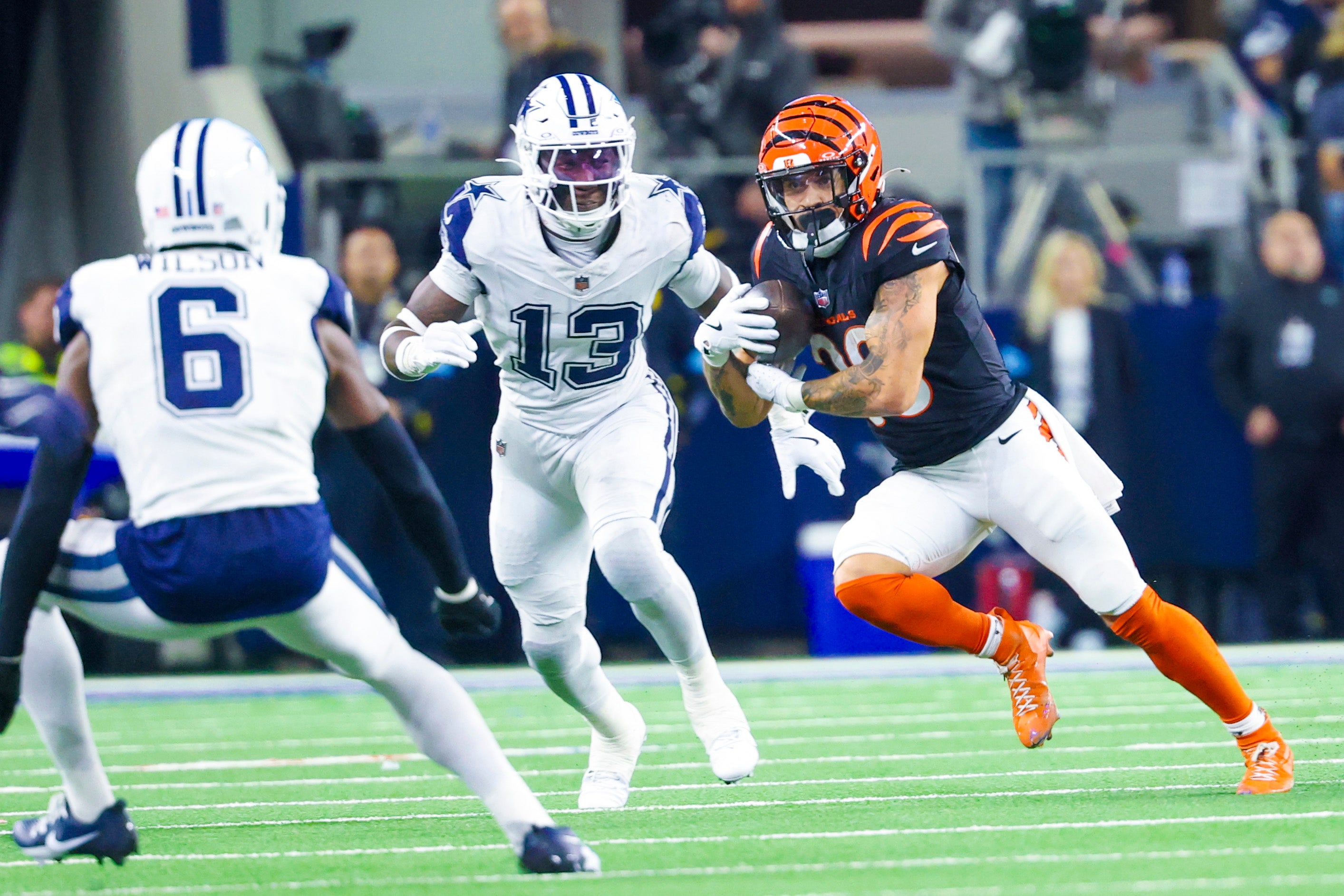 Cincinnati Bengals running back Chase Brown (30) runs with the ball as Dallas Cowboys linebacker DeMarvion Overshown (13) defends during the second half at AT&T Stadium.