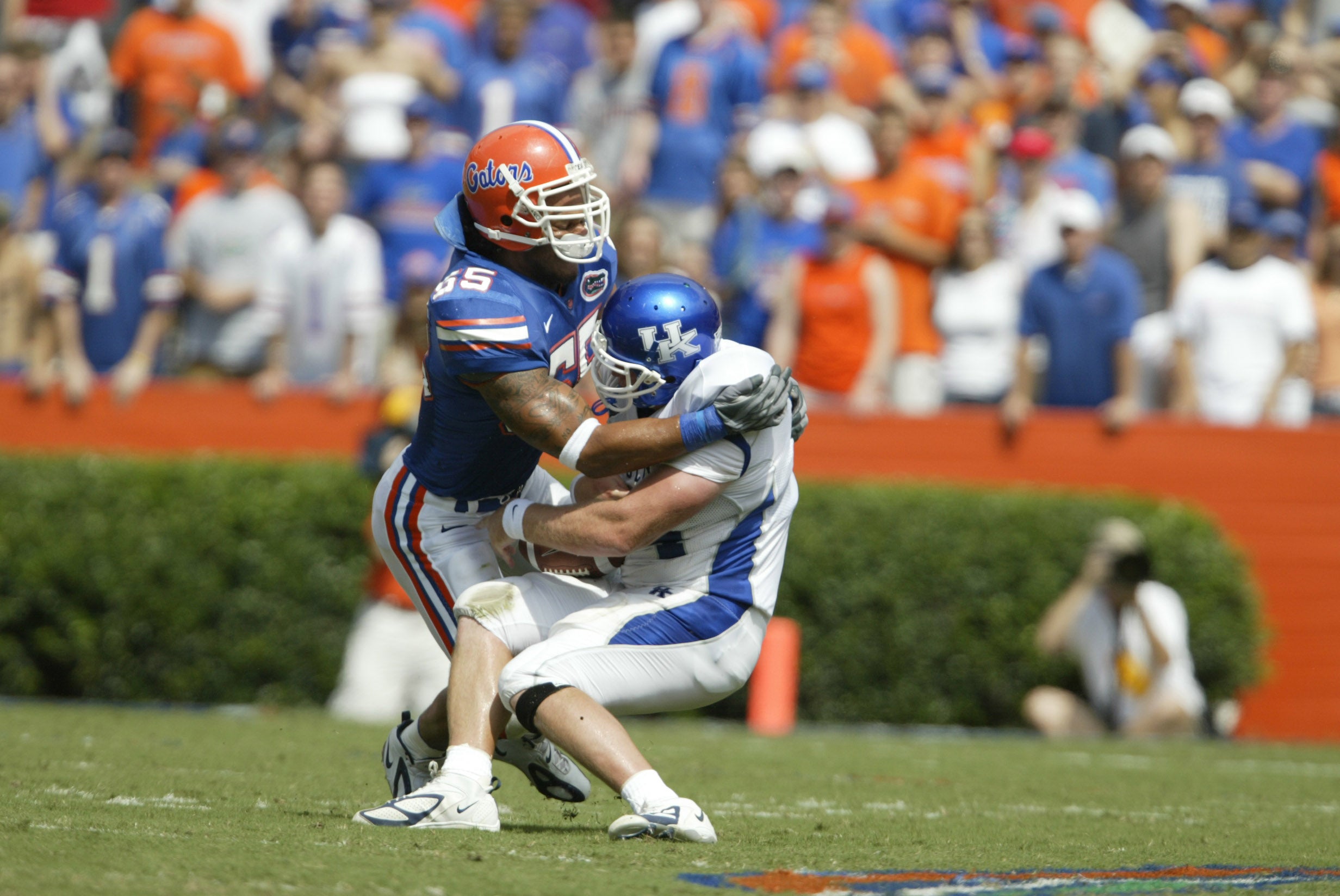 Florida Gators linebacker #55 Channing Crowder tackles Kentucky Wildcats tight end #84 Jeremiah Drobney in first half action at Ben Hill Griffin Stadium.