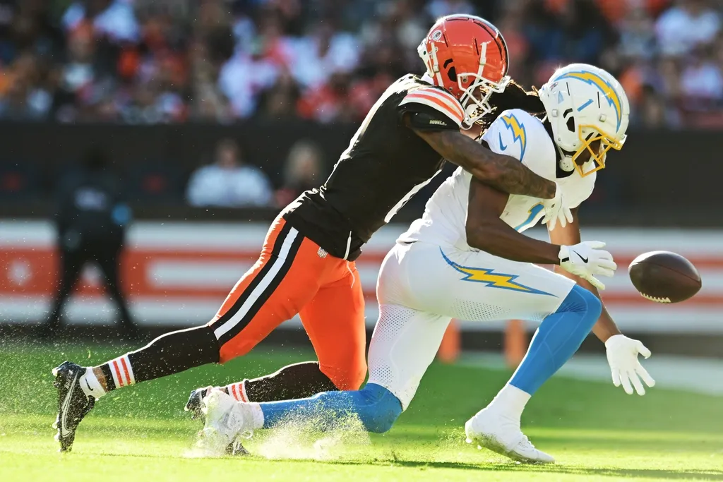 Cleveland Browns cornerback Greg Newsome II (0) knocks the ball away from Los Angeles Chargers wide receiver Quentin Johnston (1) during the second half at Huntington Bank Field.