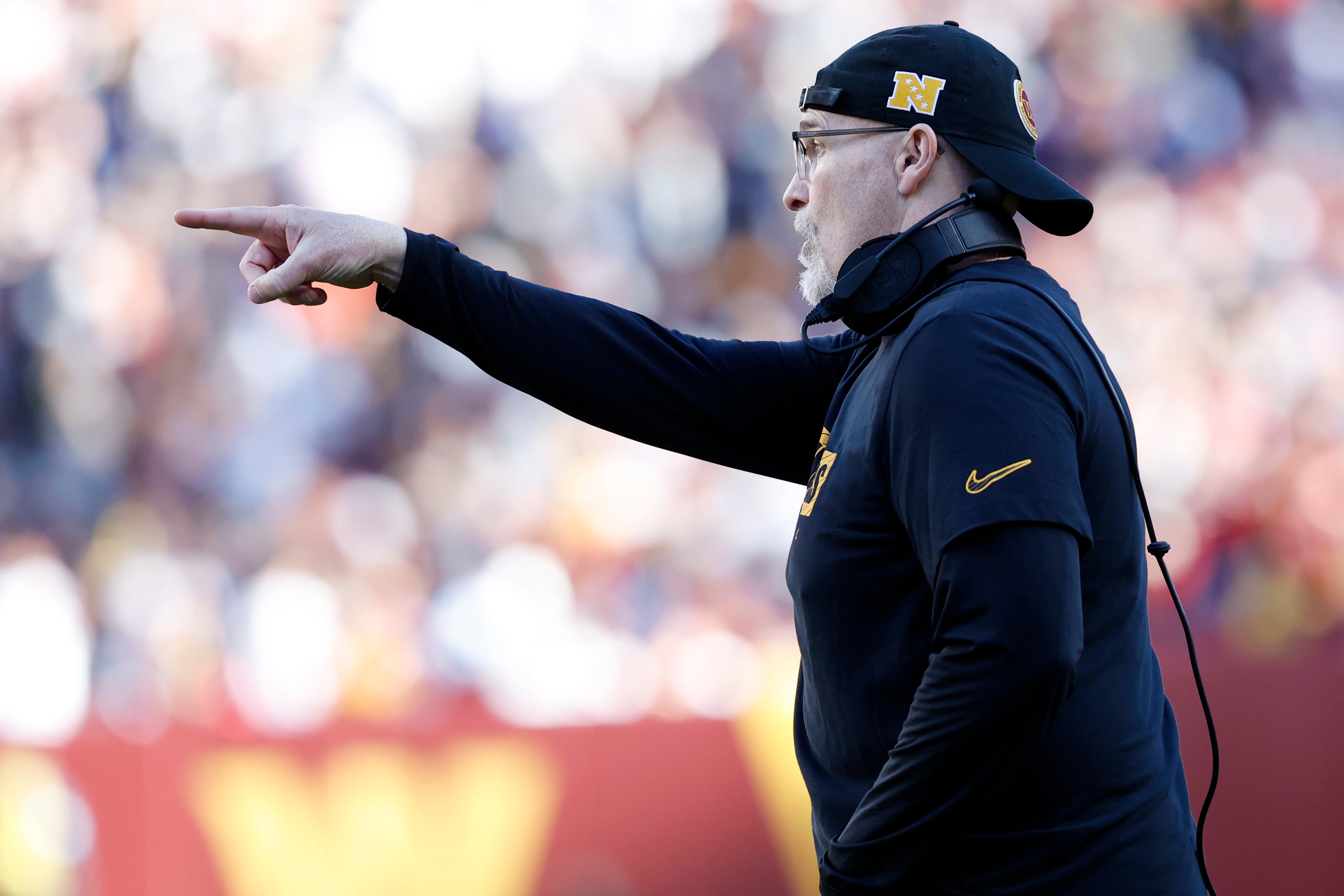 Nov 24, 2024; Landover, Maryland, USA; Washington Commanders head coach Dan Quinn gestures from the sidelines against the Dallas Cowboys during the second quarter at Northwest Stadium.