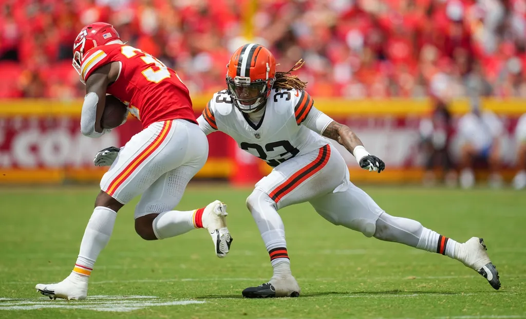 Cleveland Browns safety Ronnie Hickman (33) tackles Kansas City Chiefs running back Deneric Prince (34) during the second half at GEHA Field at Arrowhead Stadium.