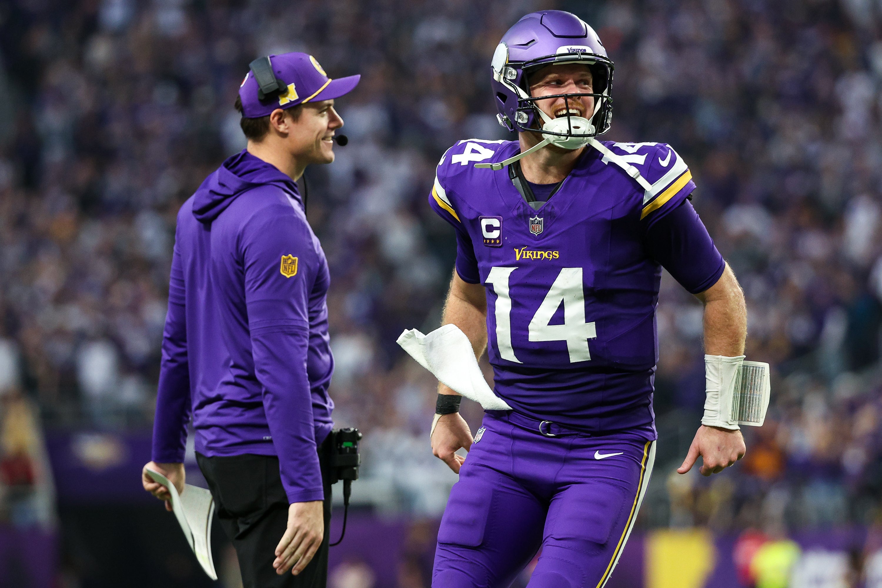 Dec 8, 2024; Minneapolis, Minnesota, USA; Minnesota Vikings quarterback Sam Darnold (14) celebrates running back Aaron Jones' (33) touchdown run with head coach Kevin O'Connell during the fourth quarter against the Atlanta Falcons at U.S. Bank Stadium.