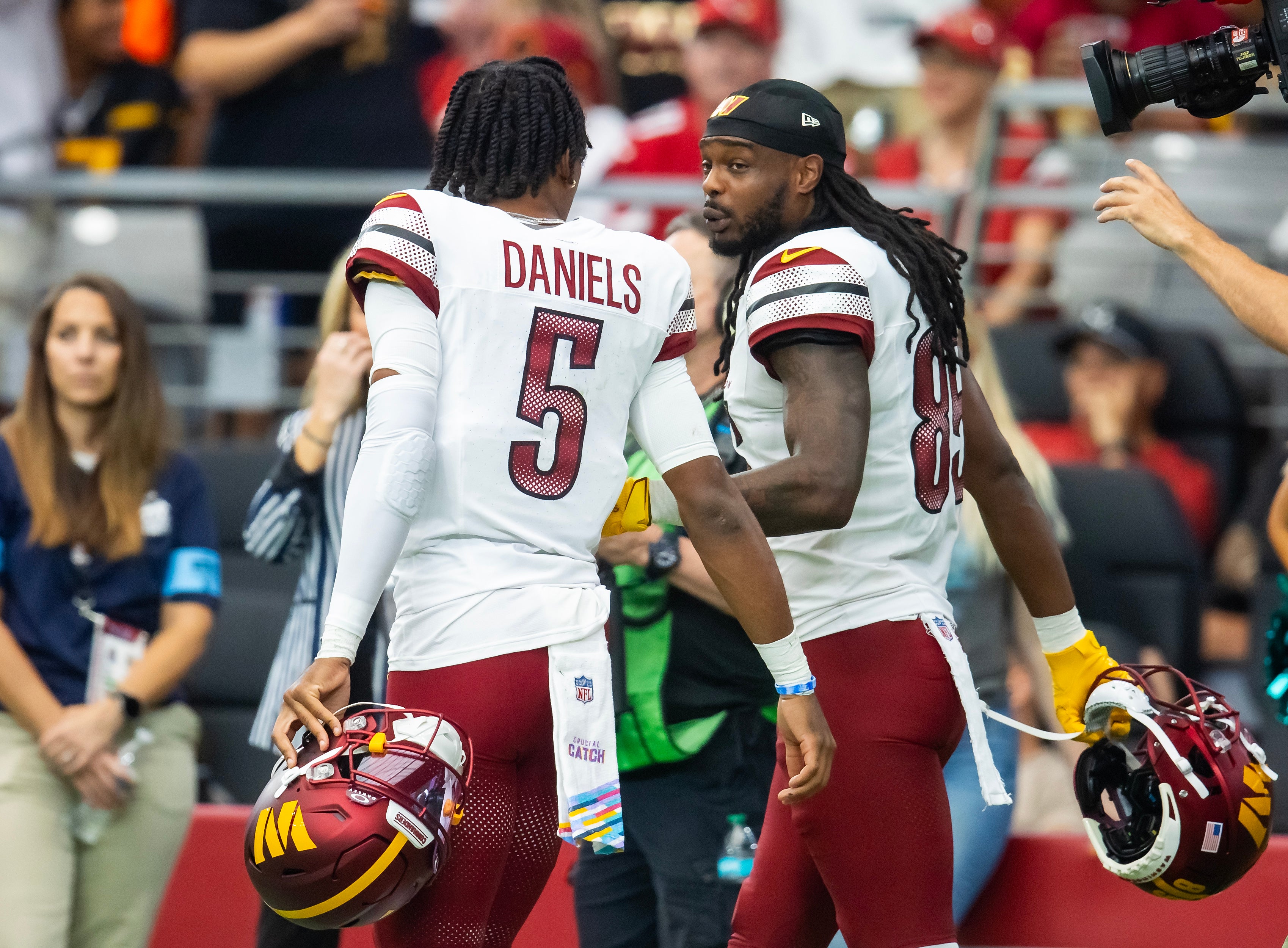 Sep 29, 2024; Glendale, Arizona, USA; Washington Commanders quarterback Jayden Daniels (5) with wide receiver Noah Brown (85) against the Arizona Cardinals at State Farm Stadium.