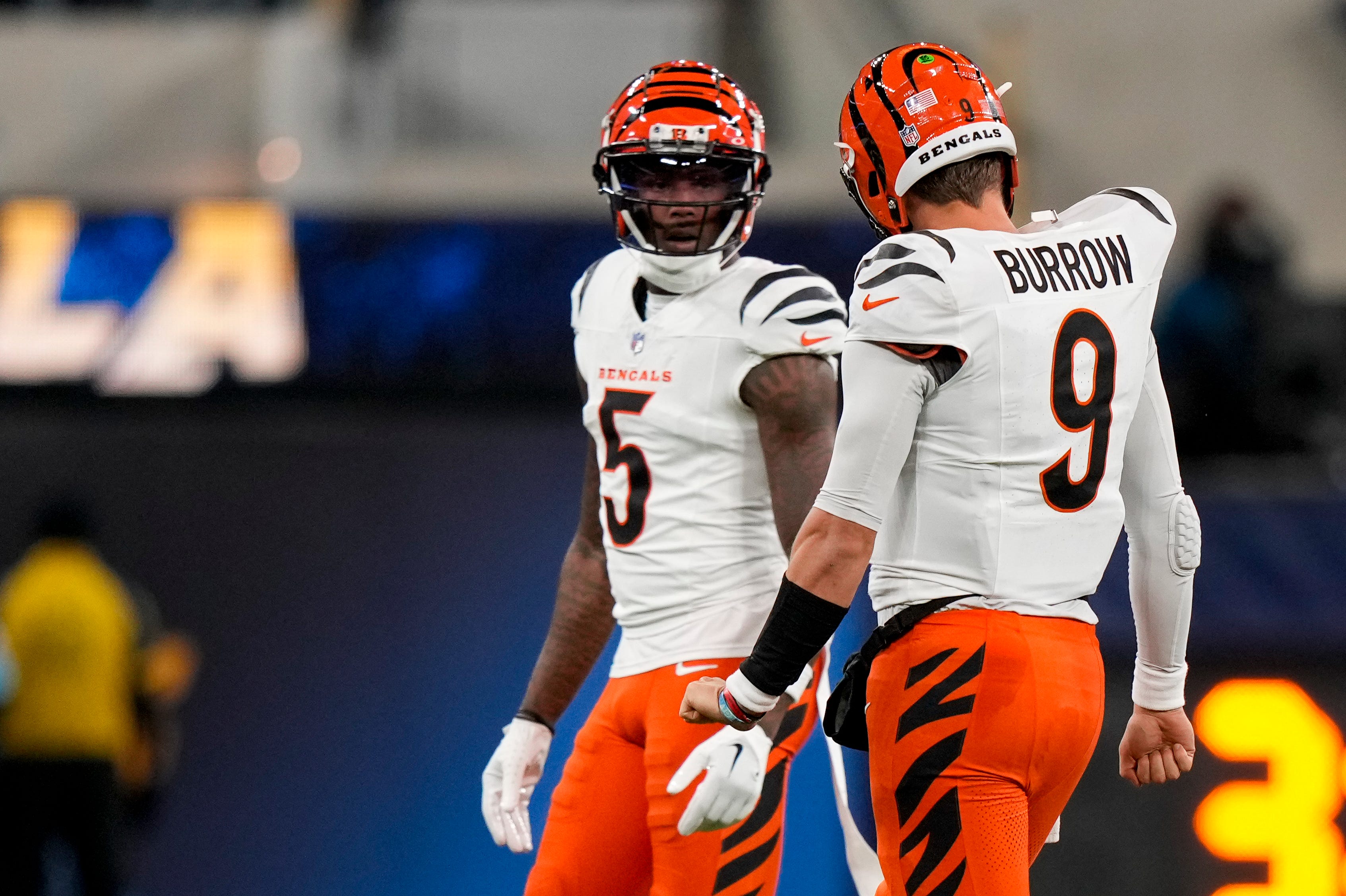 Cincinnati Bengals quarterback Joe Burrow (9) talks with wide receiver Tee Higgins (5) after a play as the punting team takes the field in the second quarter of the NFL Week 11 game between the Los Angeles Chargers and the Cincinnati Bengals at SoFi Stadium in Inglewood, Calif., on Sunday, Nov. 17, 2024. The Chargers led 24-6 at halftime.