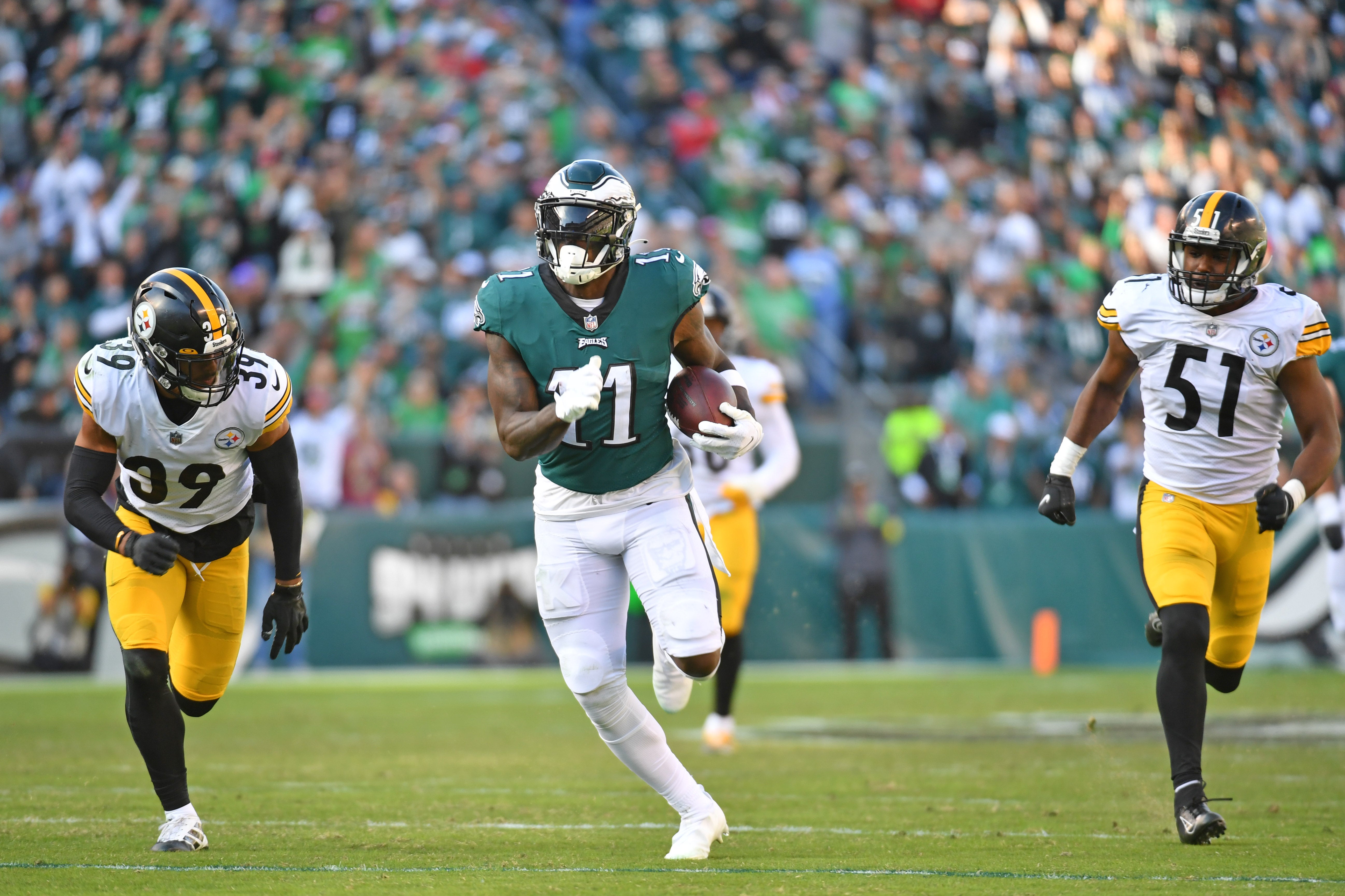 Oct 30, 2022; Philadelphia, Pennsylvania, USA; Philadelphia Eagles wide receiver A.J. Brown (11) runs past Pittsburgh Steelers safety Minkah Fitzpatrick (39) and linebacker Myles Jack (51) during the fourth quarter at Lincoln Financial Field.
