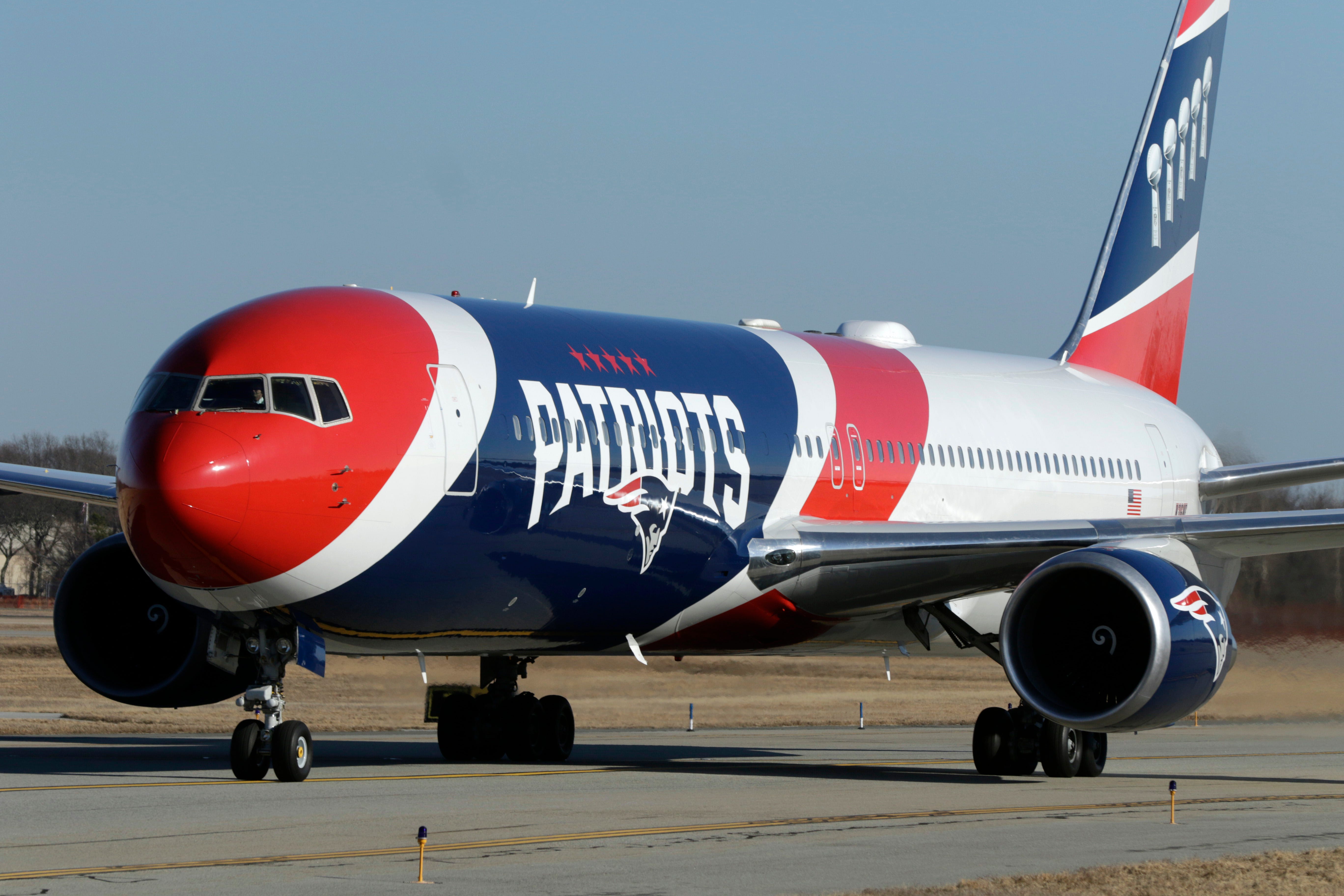Fans line the fence at parking lot E to see the New England Patriots arrive at T.F. Green International Airport returning from Atlanta and their Super Bowl LIII win against the Los Angeles Rams in Super Bowl LIII (53) at the Mercedes-Benz Stadium in Atlanta, GA.