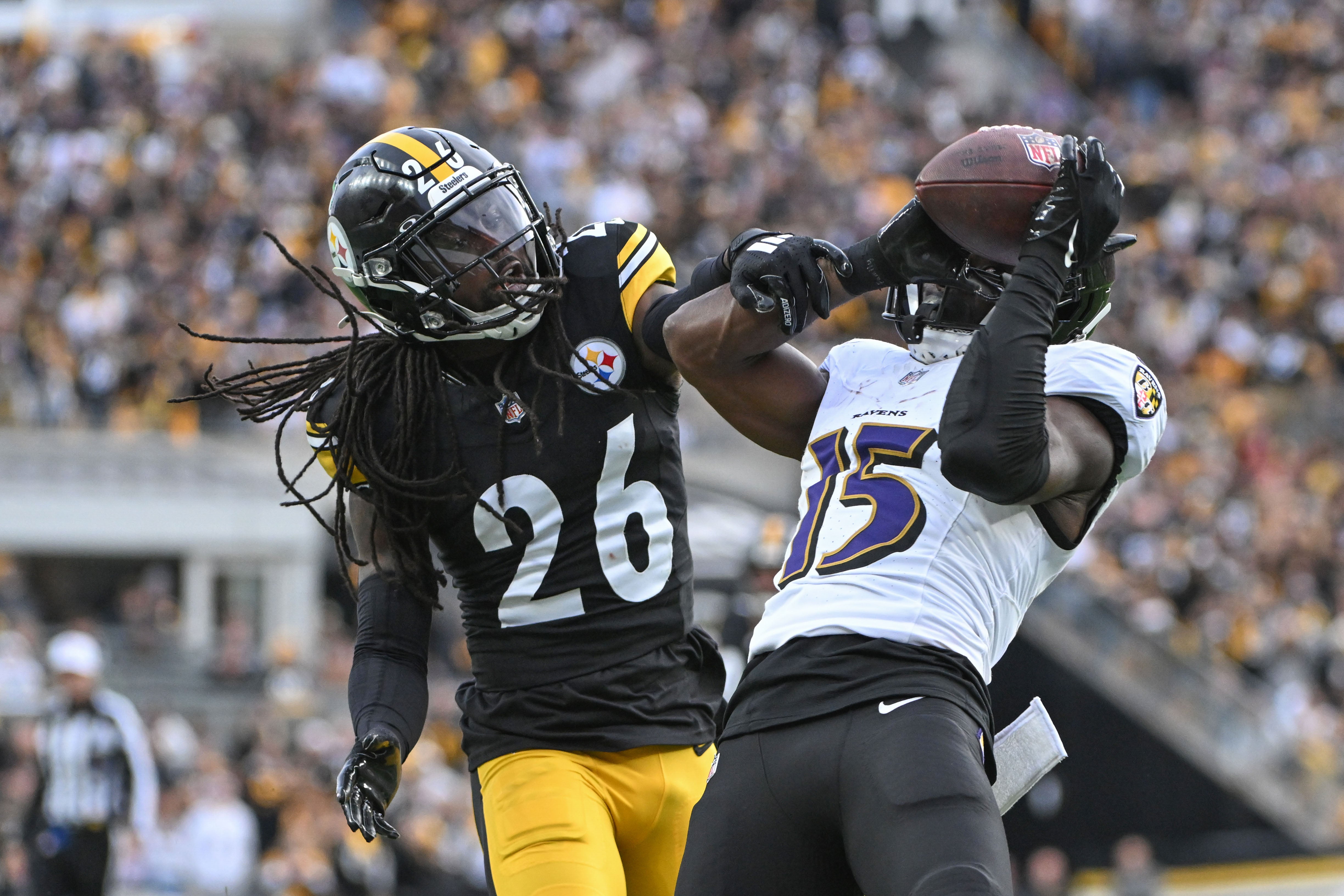 Nov 17, 2024; Pittsburgh, Pennsylvania, USA; Pittsburgh Steelers cornerback Donte Jackson (26) battles Baltimore Ravens wide receiver Nelson Agholor (15) for pass during the fourth quarter at Acrisure Stadium.