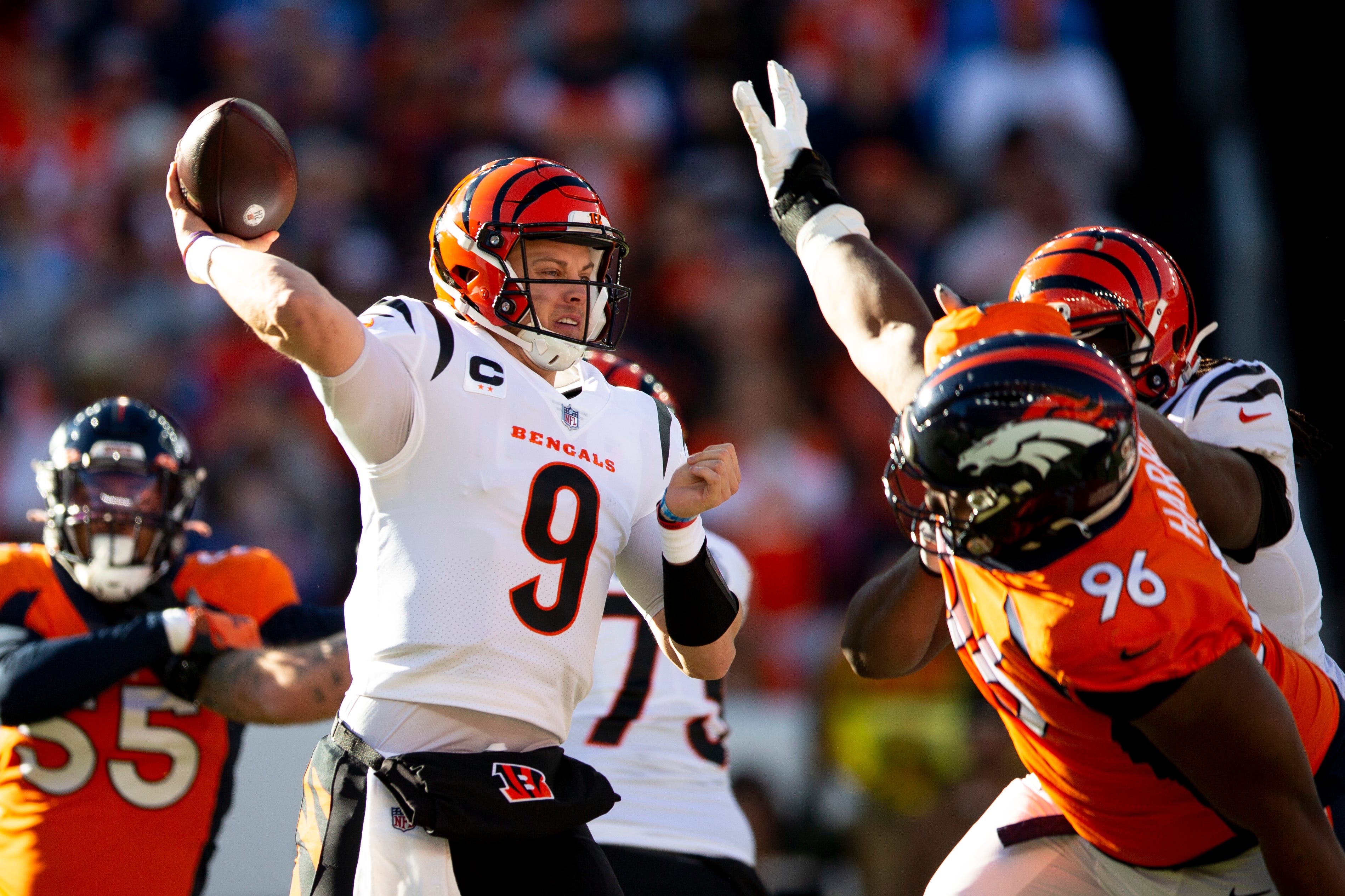 Cincinnati Bengals quarterback Joe Burrow (9) throws a pass as Denver Broncos defensive end Shelby Harris (96) pressures him in the first half of the NFL football game between the Bengals and the Broncos on Sunday, Dec. 19, 2021, at Empower Field in Denver. Cincinnati Bengals At Denver Broncos 373