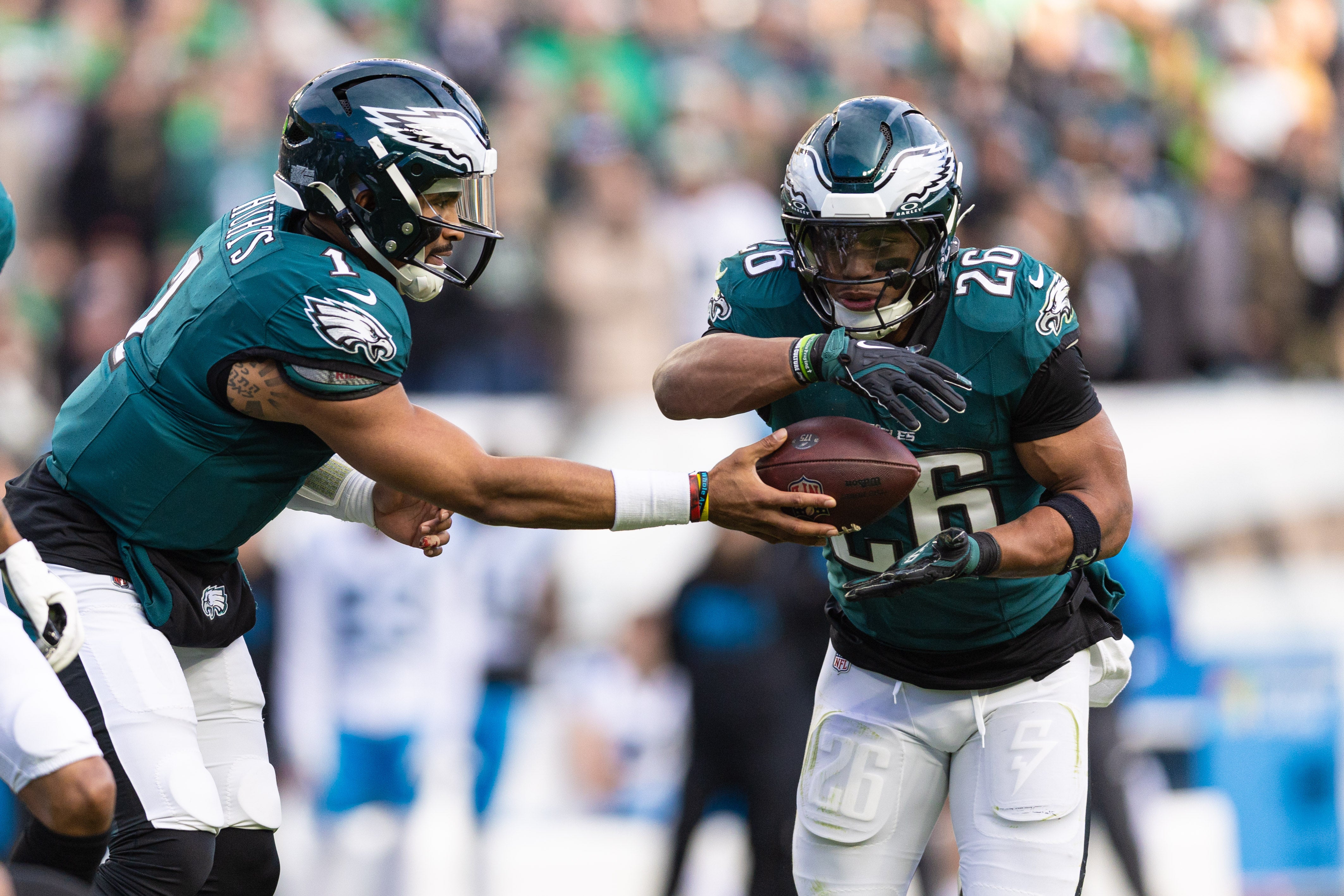 Philadelphia Eagles quarterback Jalen Hurts (1) hands off to running back Saquon Barkley (26) during the third quarter against the Carolina Panthers at Lincoln Financial Field.