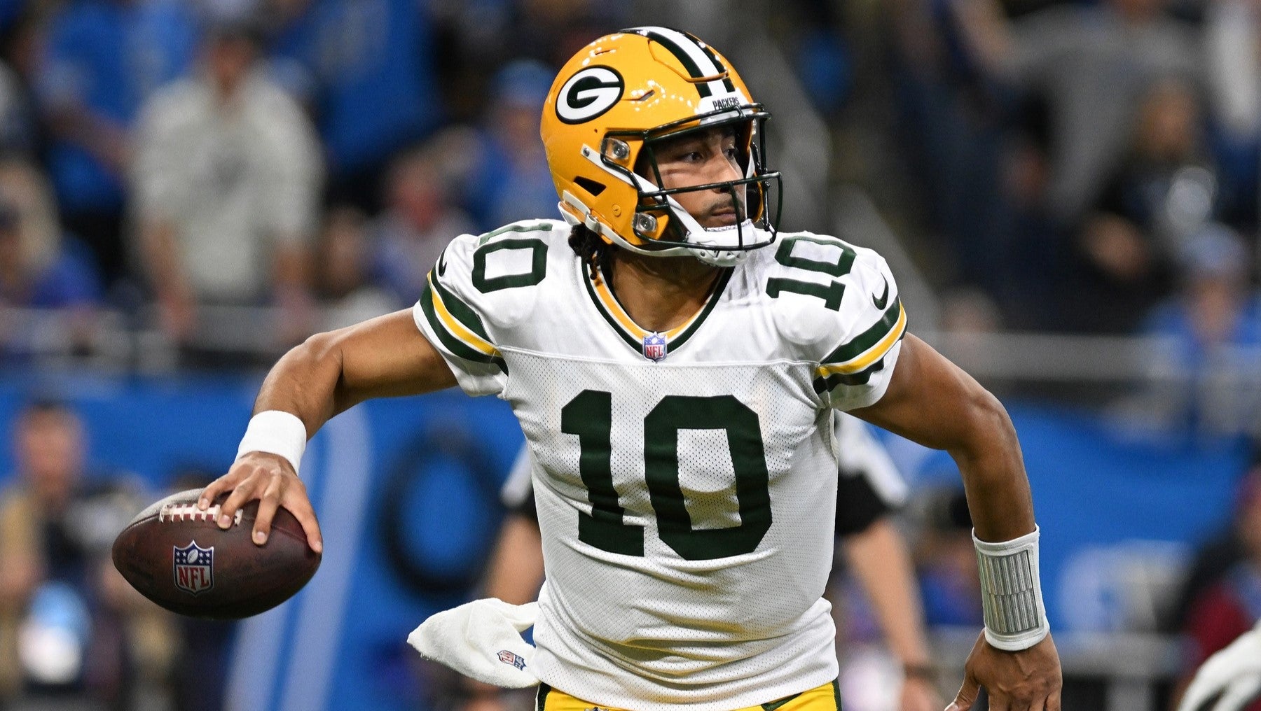 Dec 5, 2024; Detroit, Michigan, USA; Green Bay Packers quarterback Jordan Love (10) looks for an open receiver as he scrambles out of the pocket against the Detroit Lions in the third quarter at Ford Field.