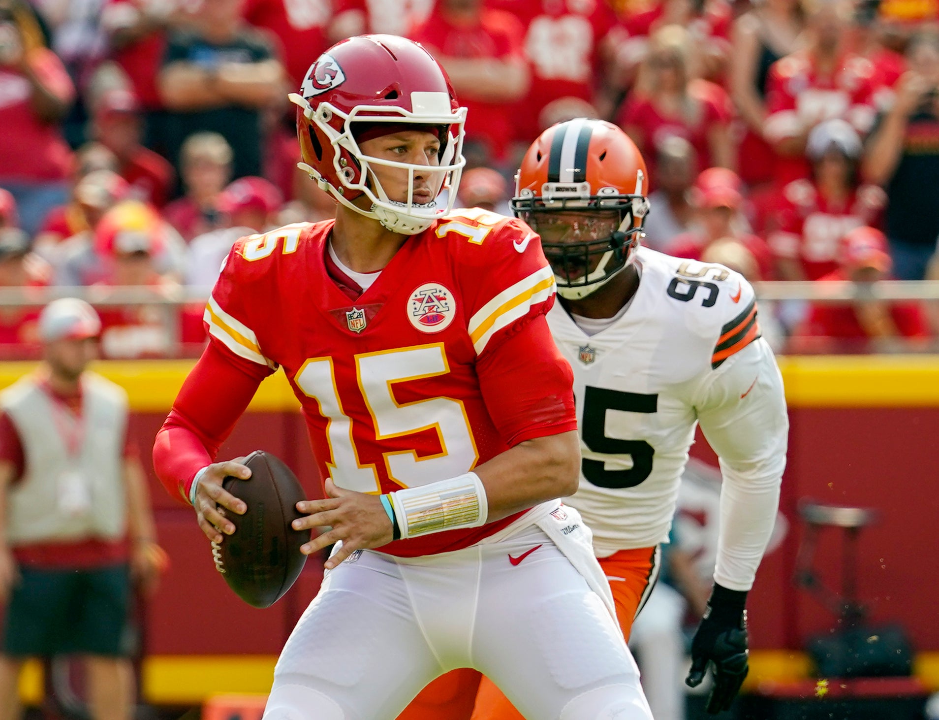 Sep 12, 2021; Kansas City, Missouri, USA; Kansas City Chiefs quarterback Patrick Mahomes (15) throws a pass as Cleveland Browns defensive end Myles Garrett (95) defends at GEHA Field at Arrowhead Stadium.